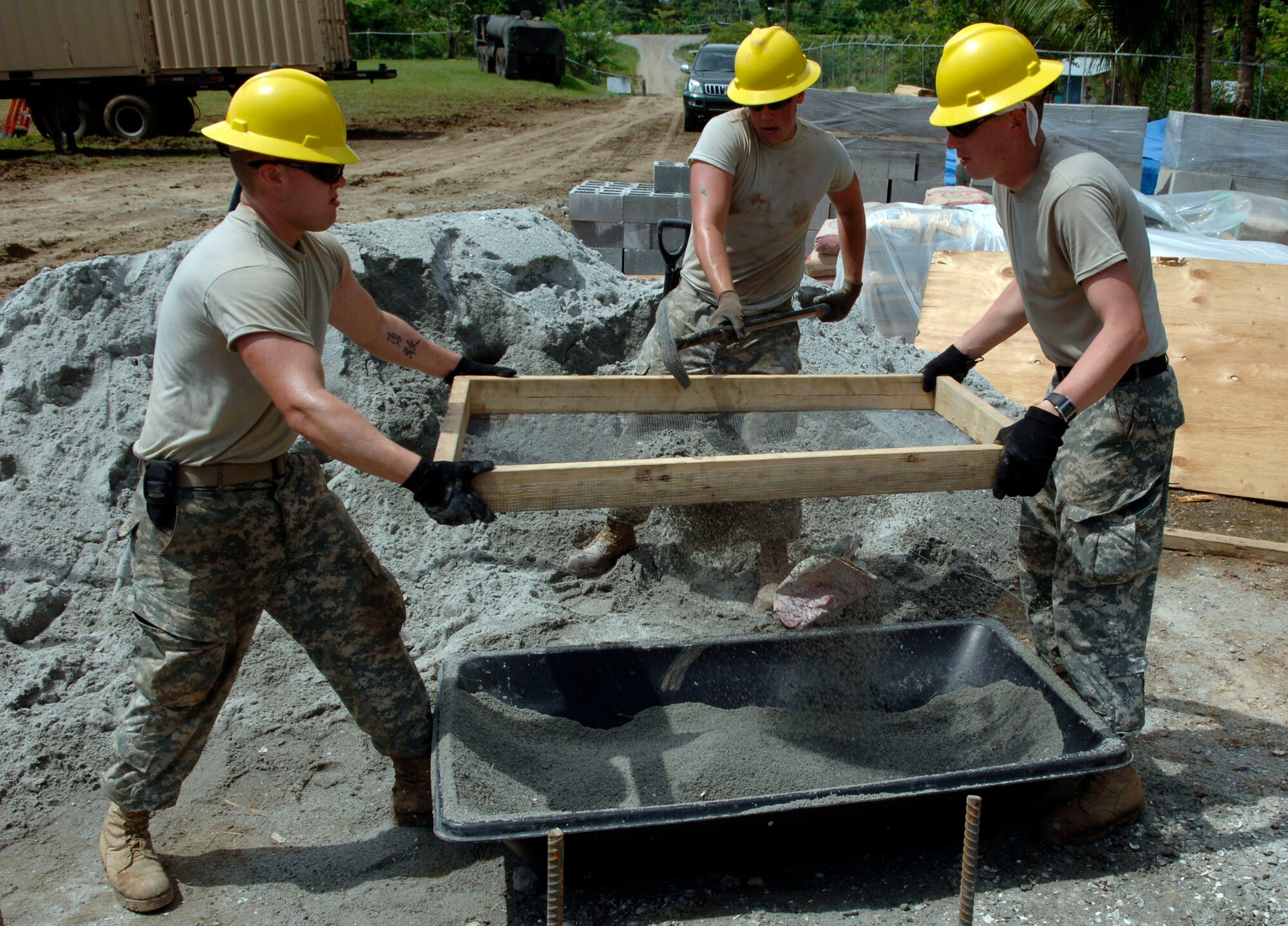 Pfc. Abel Scott (from left to right), Pfc. Wayne Paliwoda, and Pvt. Michael Culver, construction engineers with the 372nd Engineer Company, sift material to make concrete June 26 at Santa Librada elementary school in Panama. The Army Reservists are deployed in support of New Horizons Panama 2010, a humanitarian assistance mission designed to strengthen partnerships between the United States and Panama. (U.S. Air Force photo/Tech. Sgt. Eric Petosky)