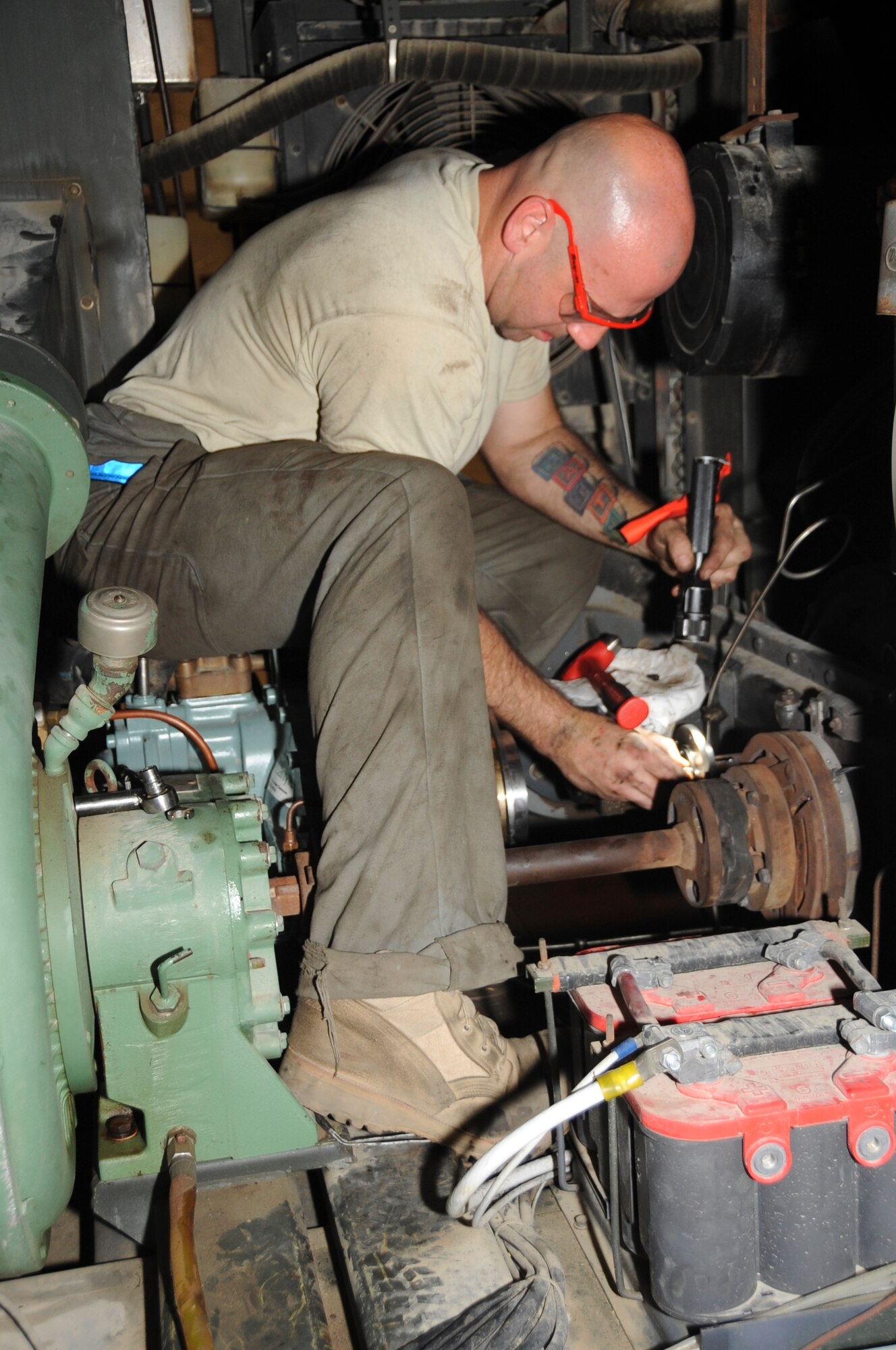 Staff Sgt. Robert Combs, 380th Expeditionary Maintenance Squadron aerospace ground equipment craftsman, works on a MA-3D air conditioner June 25 at an undisclosed location is Southwest Asia. This type of air conditioner provides cooling air to the KC-10 Extender (U.S. Air Force photo/Tech. Sgt April Wickes) 

