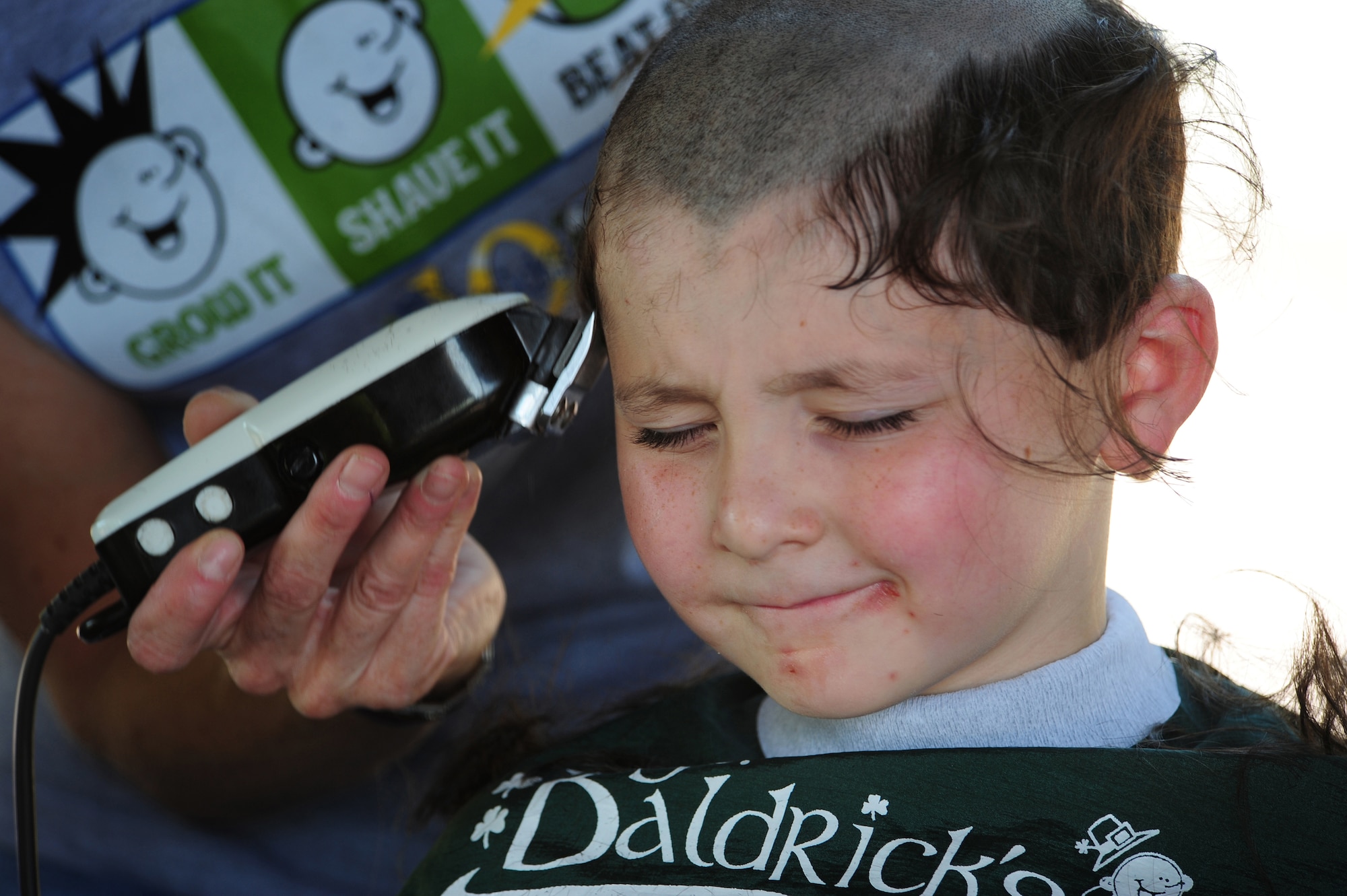 Jacob Torres, 7, son of U.S. Air Force Major Christopher Torres 603 Air and Space Operations Center deputy chief of operations, has his head shaved in participation of the first ever St. Baldrick's event held on Ramstein Air Base, Germany, June 26, 2010. The St. Baldrick's Foundation is an organization that tasks volunteers with getting sponsored to have their heads shaved as a demonstration of their camaraderie to children that have been diagnosed with cancer. (U.S. Air Force Photo by Staff Sgt. Jocelyn Rich)
