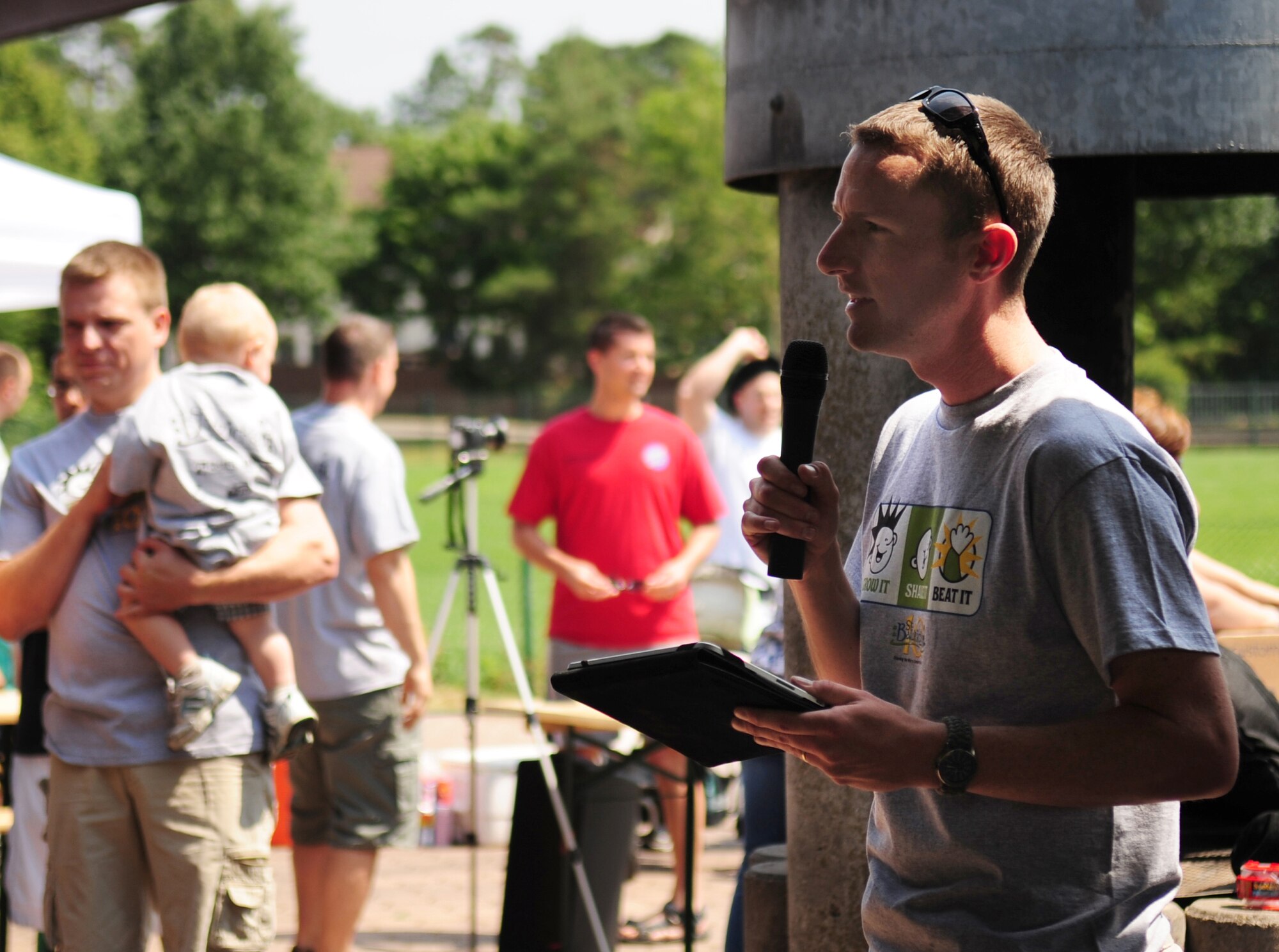 U.S. Air Force Tech. Sgt. Timothy Beardsley 86th Maintenance Squadron, makes opening comments at the first St. Baldrick's event held on Ramstein Air Base, Germany, June 26, 2010. Tech. Sgt. Beardsley and his wife Heike organized the event in their three-year-old daughter, Josie's honor. Josie was diagnosed with Leukemia two years ago. The St. Baldrick's Foundation is an organization that tasks volunteers with getting sponsored to have their heads shaved as a demonstration of their camaraderie to children that have been diagnosed with cancer. (U.S. Air Force photo by Staff Sgt. Jocelyn Rich)