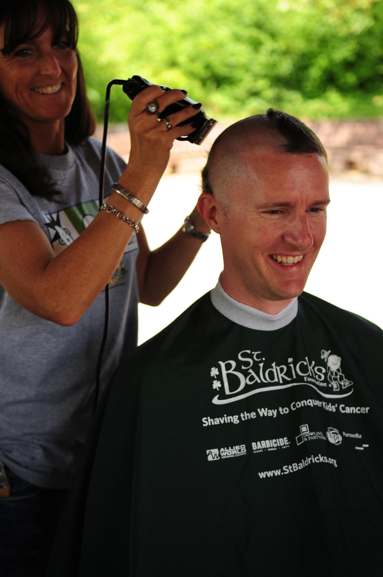 U.S. Air Force Tech. Sgt. Timothy Beardsley 86th Maintenance Squadron has his head shaved by volunteer Heike Lauer, in participation of the St. Baldrick's event that he and his wife Heike organized in their 3-year-old daughter, Josie's honor. Josie was diagnosed with Leukemia two years ago today, Ramstein Air Base Germany, June 26, 2010. The St. Baldrick's Foundation is an organization that tasks volunteers with getting sponsored to have their heads shaved as a demonstration of their camaraderie to children that have been diagnosed with cancer. (U.S. Air Force Photo by Staff Sgt. Jocelyn Rich)