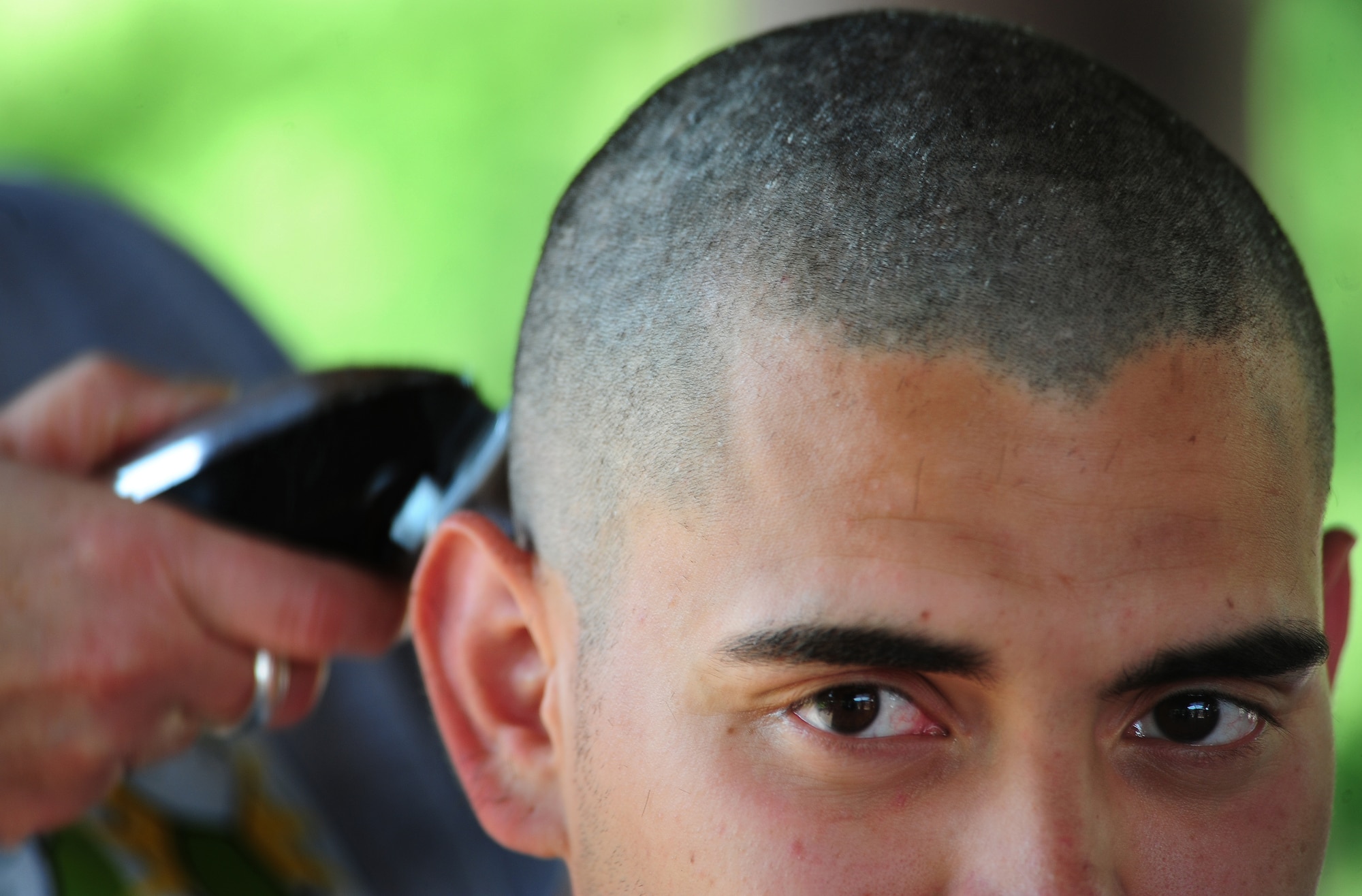 U.S. Air Force Senior Airman Miguel Mascorro, 86th Maintenance Squadron, has his head shaved as he participates in the first St. Baldrick's event held on Ramstein Air Base, Germany, June 26, 2010. The St. Baldrick's Foundation is an organization that tasks volunteers with getting sponsored to have their heads shaved as a demonstration of their camaraderie to children that have been diagnosed with cancer. (U.S. Air Force photo by Staff Sgt. Jocelyn Rich)