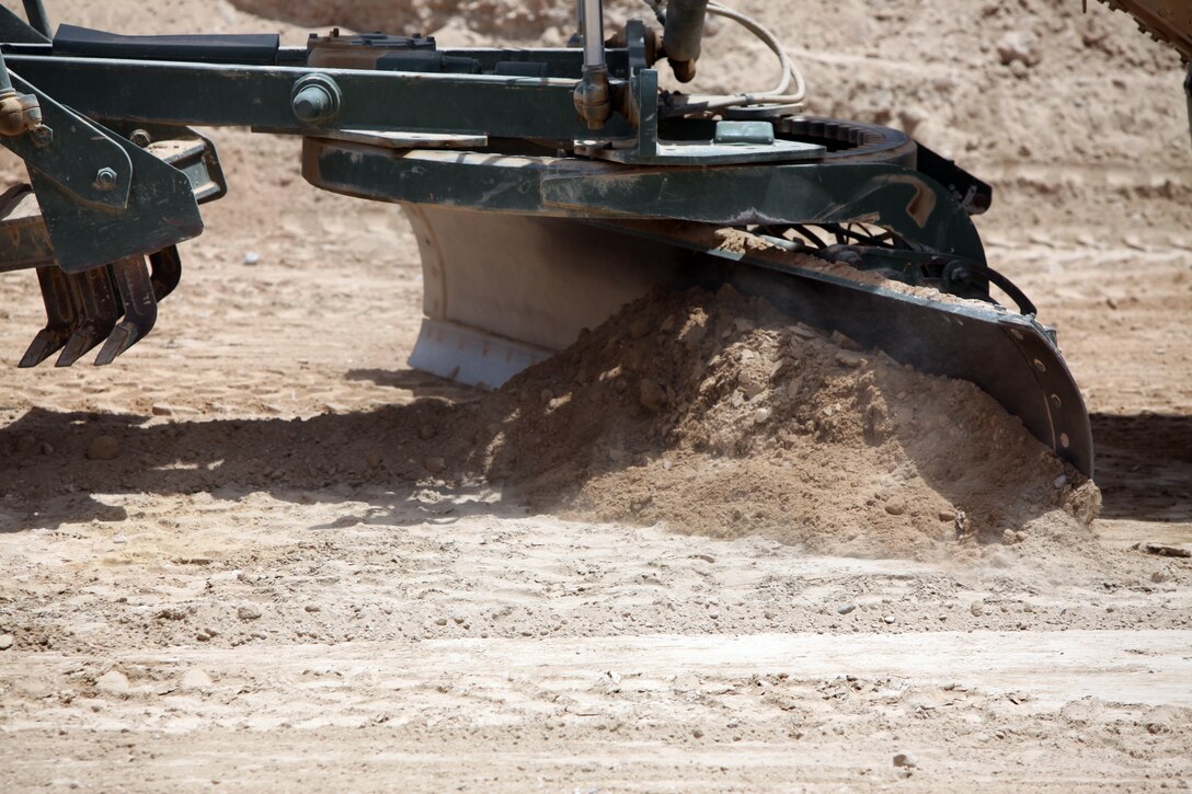 Lance Cpl. Alex L. Dore, 22, from Muskegon, Mich., security personnel with Security Platoon, 9th Engineer Support Battalion, 1st Marine Logistics Group (Forward), posts security at the site of a bridge construction project in northern Marjah, Helmand Province, Afghanistan, June 26. Curious Afghan villagers often approached to watch as Marines, soldiers and sailors constructed a bridge near their village.