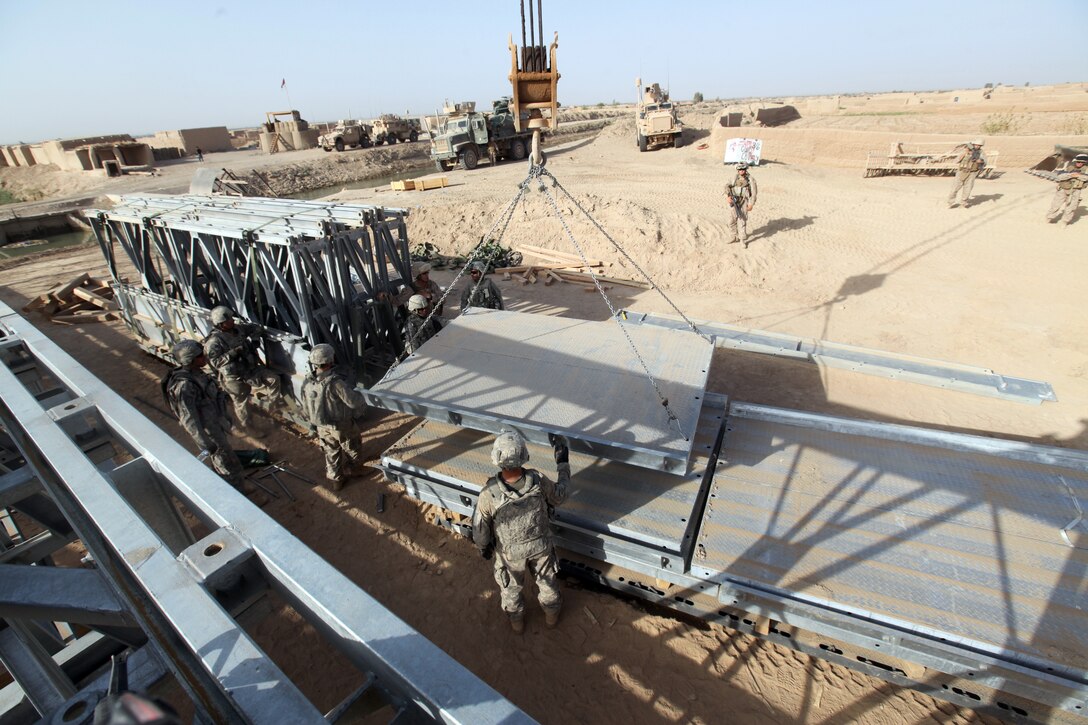 Marines, sailors and soldiers worked side-by-side in a joint operation to build a bridge in northern Marjah, Helmand Province, Afghanistan, June 26. The purpose of the bridge is to provide more freedom of movement for locals and safer access to Marjah for coalition forces.