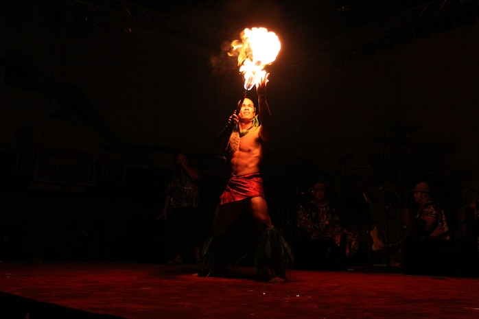 Mervyn Lilo, the lead male dancer for Ma’ohi Nui, reaches up to touch a ball of fire during the Luau held at the IronWorks Gym here June 26. This was part of the Samoan fire dance Lilo performed.