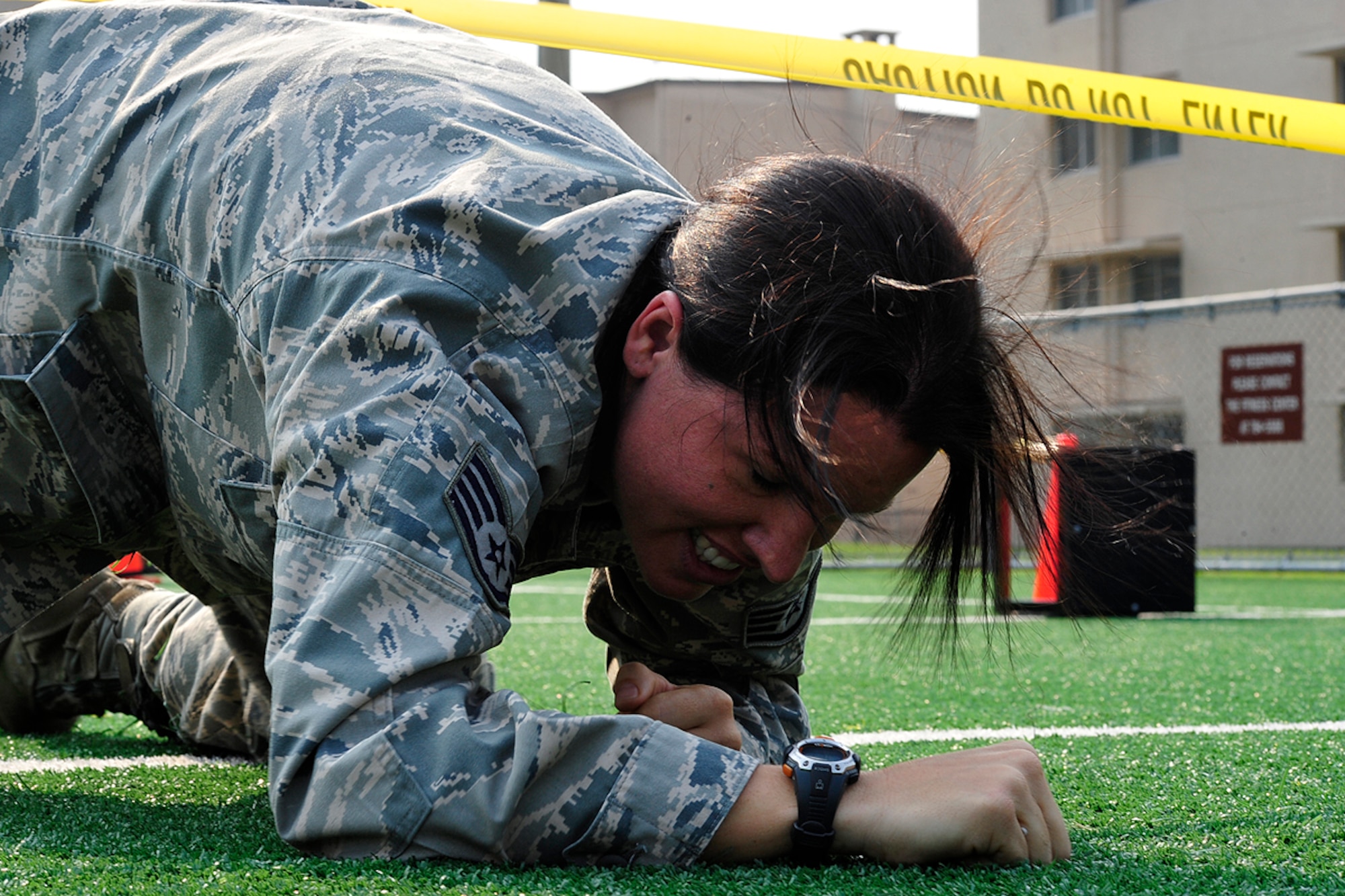 Staff Sgt. Melenie Rogers, 51st Operations Support Squadron, completes a 100 ft. low crawl during a Warrior Challenge competition, put on by the Osan Fitness Center. Throughout the competition four teams were timed as they completed several physical tasks. The team with the fastest time won trophies for each of its members. (U.S. Air Force photo/ Staff Sgt. Eunique Stevens)