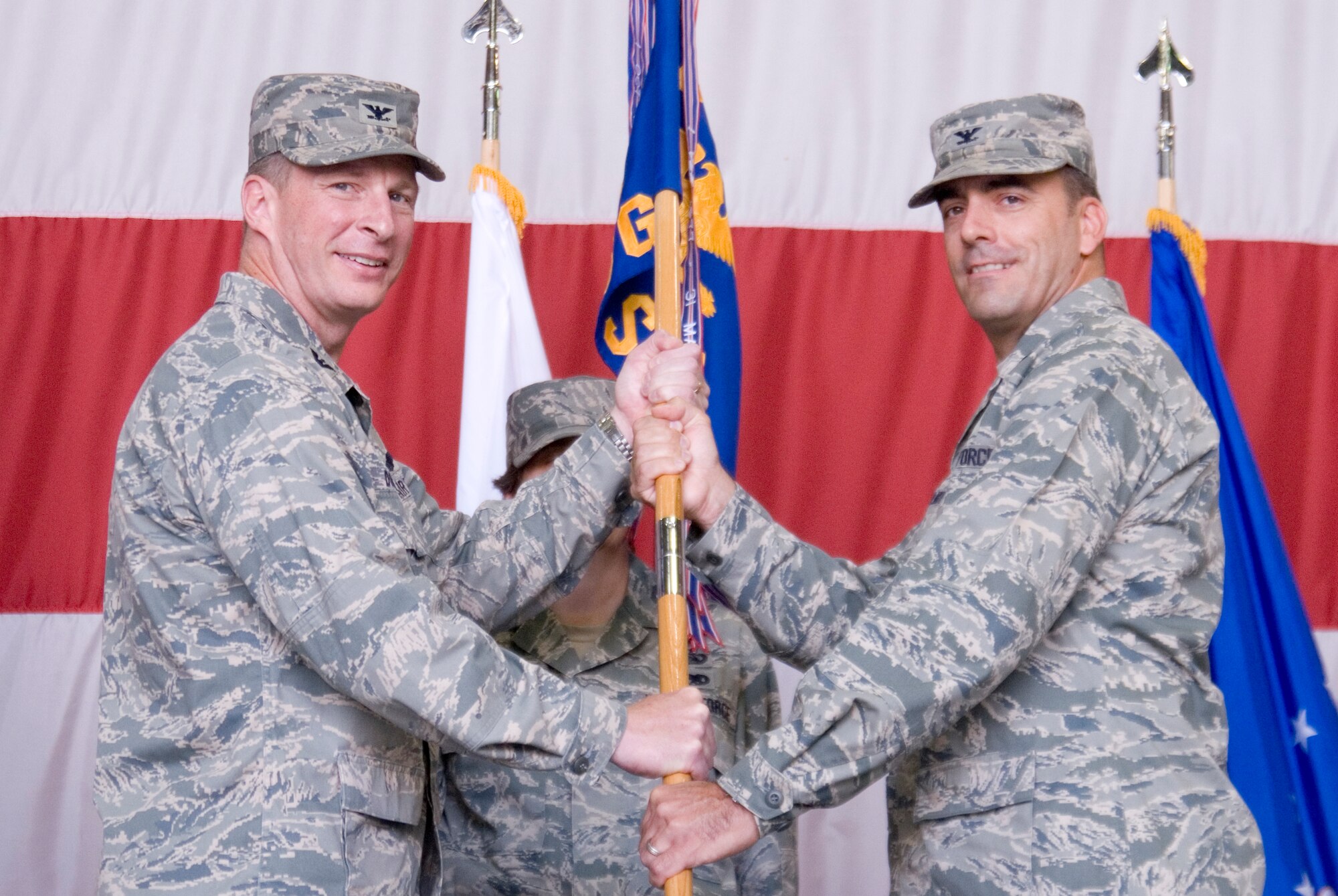 KUNSAN AIR BASE, Republic of Korea --  Col. John Dolan, 8th Fighter Wing commander, presents the guidion to Col. Richard Palmieri during the 8th Mission Support Group Change of Command ceremony June 24. Col. Palmieri is replacing the former MSG commander, Col. Patrick Clements. (U.S. Air Force photo/Staff Sgt. Jonathan Pomeroy)