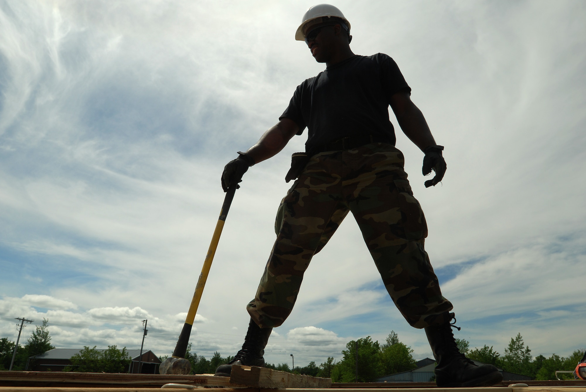 Members of the 433rd Civil Engineering Squadron conduct a humanitarian mission in the Red Lake Indian Reservation for the Red Lake band of Chippewa Indians, just outside of Bemidji, Minnesota. Tech. Sgt. Mark Johnson, 433rd CES, holds the hammer he uses to align the sheets of plywood used for the subfloor.(U.S. Air Force photo/Airman 1st Class Brian McGloin)