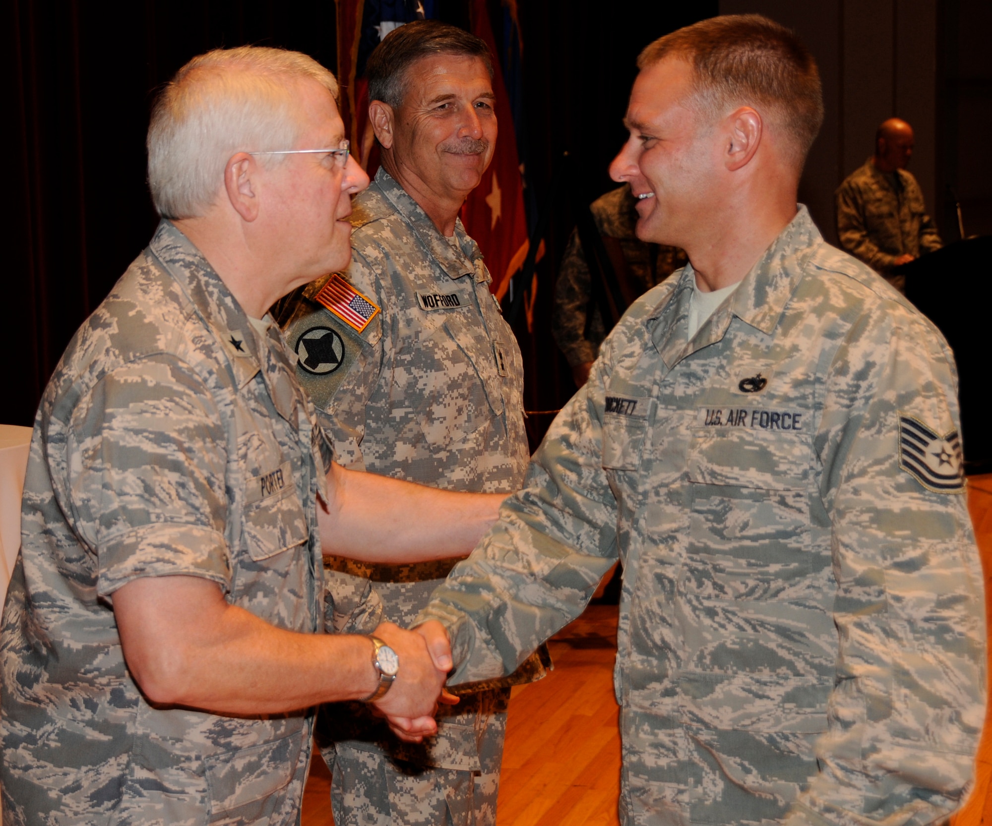 An Airman with the 188th Fighter Wing shakes hands with Brig. Gen. Riley Porter, commander of the Arkansas Air National Guard, during a Hometown Heroes Salute program held at the Fort Smith (Ark.) Convention Center June 26, 2010. More than 300 Airmen with the Arkansas Air National Guard's 188th along with their respective families were honored for their sacrifices during the event. The purpose was to honor 188th Airmen for service in support of Operation Enduring Freedom and Operation Iraqi Freedom from Sept. 11, 2001 through Dec. 31, 2008.  (U.S. Air Force photo by Tech Sgt. Stephen Hornsey/188th Fighter Wing Public Affairs)
