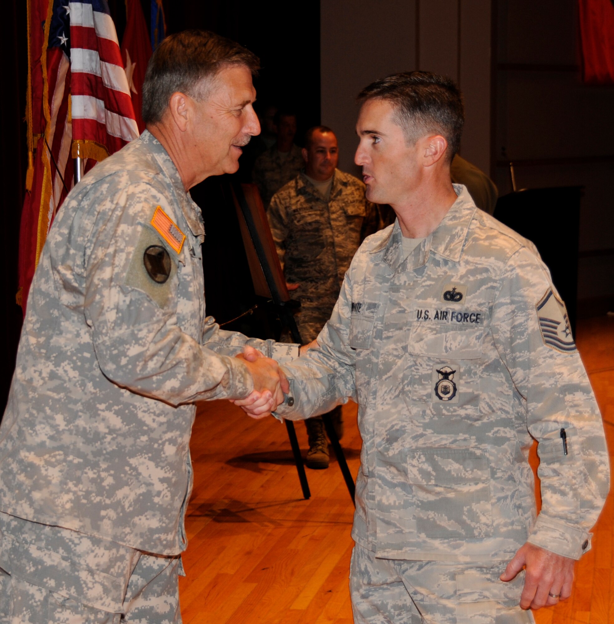 Master Sgt. Ron White, an Airman with the 188th Fighter Wing Security Forces Squadron, shakes hands with Maj. Gen. William Wofford, adjutant general for the Arkansas National Guard, during a Hometown Heroes Salute program held at the Fort Smith (Ark.) Convention Center June 26, 2010. More than 300 Airmen with the Arkansas Air National Guard's 188th along with their respective families were honored for their sacrifices during the event. The purpose was to honor 188th Airmen for service in support of Operation Enduring Freedom and Operation Iraqi Freedom from Sept. 11, 2001 through Dec. 31, 2008.   (U.S. Air Force photo by Tech Sgt. Stephen Hornsey/188th Fighter Wing Public Affairs)
