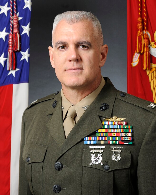Major Gen. Raymond C. Fox passes on his duties as commanding general of the 1st Marine Aircraft Wing to Brig. Gen. William D. Beydler during a change of command ceremony on the Futenma flight line Monday. ::r::::n::