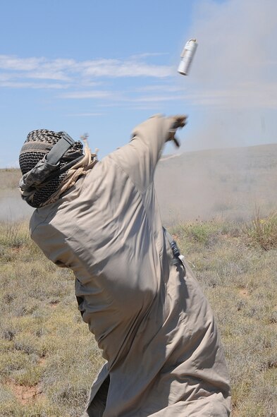 Mr. Buddy Gurnari, 27th Special Operations Support Squadron, throws a ground burst simulator towards friendly forces, June 26, 2010 as part of a Capabilities Exercise. The CAPEX was held at the Melrose Air Force Range. (U.S. Air Force Photo by Airman  1st Class Maynelinne De La Cruz) 