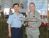 Gen. Donald Hoffman presents a Wright Flyer to Lt. Gen. Jongheon Park, commander of the Education and Training Command for the Republic of Korea Air Force at the Air Force Materiel Command Freedom's Call Tattoo June 25, 2010 at Wright-Patterson Air Force Base, Ohio.  The sixth annual event took place on the 60th anniversary of the start of the Korean War.  The Tattoo attracted more than 75,000 people for an evening of music, military ceremony, aircraft flyovers and fireworks. General Hoffman is AFMC commander.  (U.S. Air Force photo/Ben Strasser)