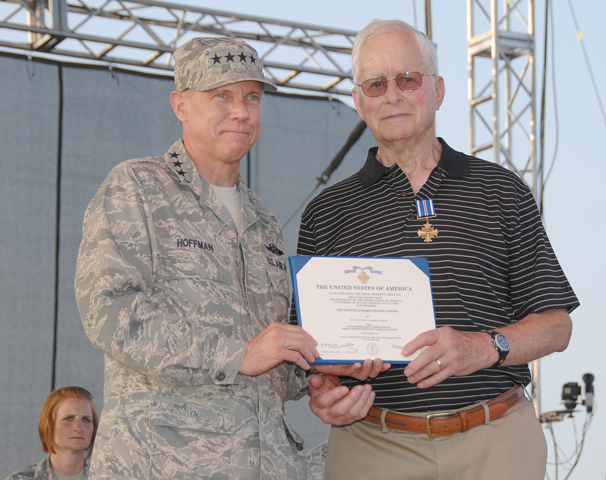 Gen. Donald Hoffman presents Ralph Hoehn with the Distinguished Flying Cross at the Air Force Materiel Command Freedom's Call Tattoo on June 25 at Wright-Patterson Air Force Base, Ohio.  During World War II, then Lieutenant Hoehn, a member of the 491st Bombardment Group, piloted B-24 Liberators for 35 missions in the skies over Europe.  The sixth annual Tattoo attracted more than 75,000 people for an evening of music, military ceremony, aircraft flyovers and fireworks. General Hoffman is AFMC commander.  (U.S. Air Force photo/Ben Strasser)