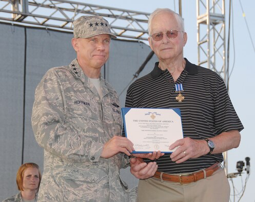 Gen. Don Hoffman, Air Force Materiel Command commander, presents Ralph Hoehn with the Distinguished Flying Cross at the AFMC Freedom's Call Tattoo on June 25, 2010, at Wright-Patterson Air Force Base, Ohio. During World War II then-Lieutenant Hoehn, a member of the 491st Bombardment Group, piloted B-24 Liberators for 35 missions in the skies over Europe.  (U.S. Air Force photo/Ben Strasser) 