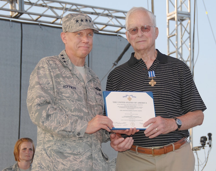 Gen. Don Hoffman, Air Force Materiel Command commander, presents Ralph Hoehn with the Distinguished Flying Cross at the AFMC Freedom's Call Tattoo on June 25, 2010, at Wright-Patterson Air Force Base, Ohio. During World War II then-Lieutenant Hoehn, a member of the 491st Bombardment Group, piloted B-24 Liberators for 35 missions in the skies over Europe.  (U.S. Air Force photo/Ben Strasser) 