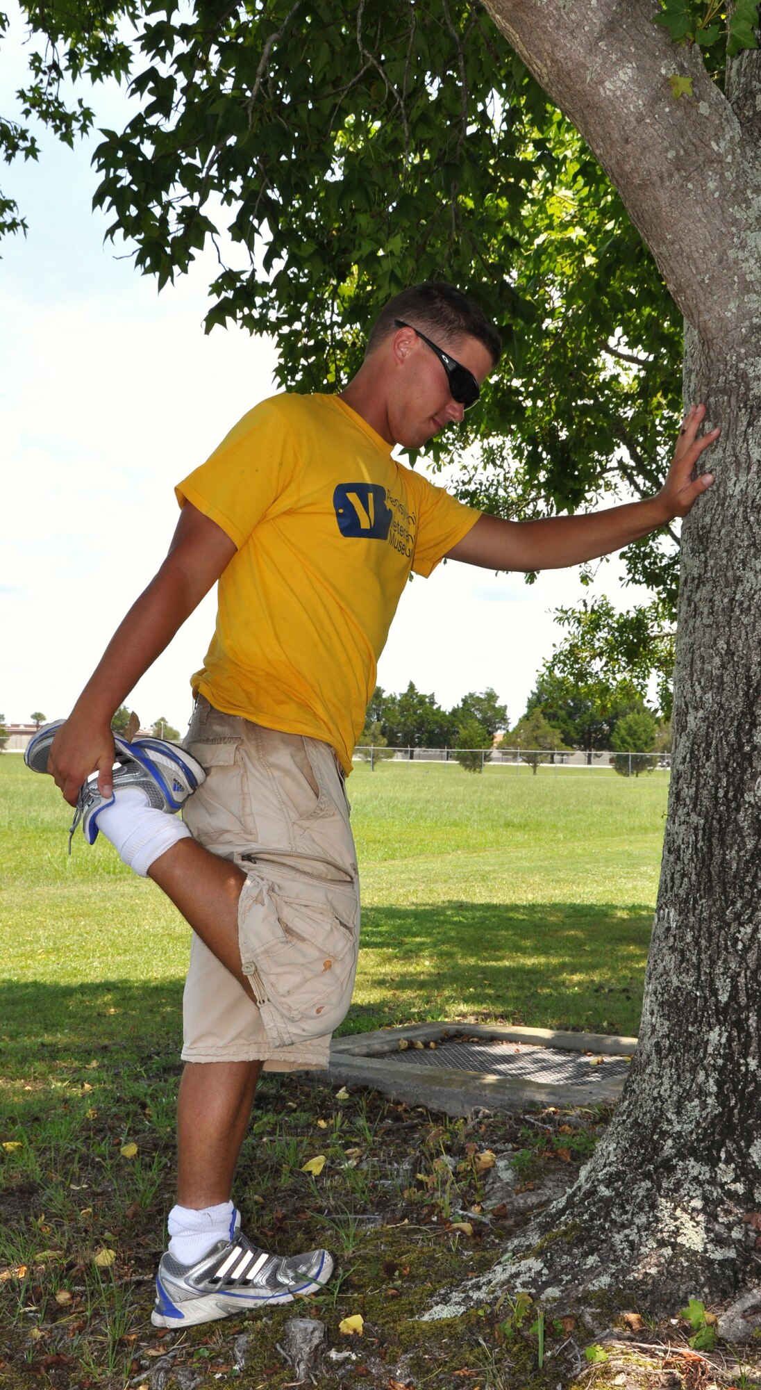 Mark Klodzinski performs stretches before he departs Tyndall Air Force Base, Fla. June 25.  Mark travels with his 45-pound book bag and plenty of water.  (U.S. Air Force photo by Senior Airman Anthony J. Hyatt)