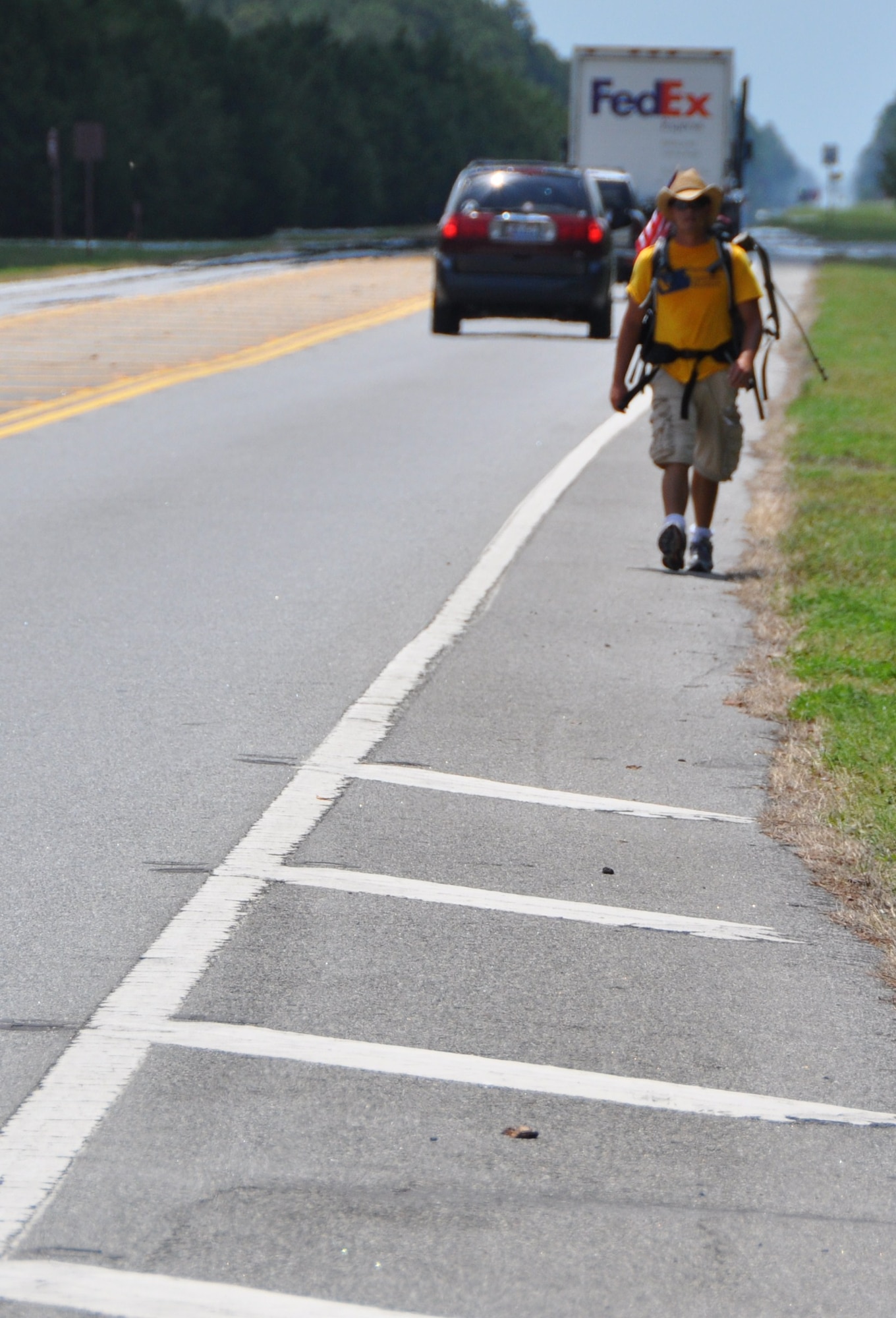 Mark Klodzinski walks along Highway 98 toward Tyndall Air Force Base, Fla. June 25.  Mark began his trip March 16, 2010 and plans to reach San Diego Dec. 10, 2010.  (U.S. Air Force photo by Senior Airman Anthony J. Hyatt)