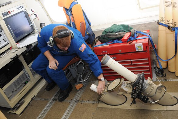 Charles Lynch, an electronics engineer for the National Oceanic and Atmospheric Administration, releases a dropsonde from a hatch in a WP-3D Orion weather research aircraft into the Gulf of Mexico during an observation flight June 25, 2010. The dropsondes measure atmospheric pressure, temperature, humidity and wind speed and direction. (U.S. Air Force photo by Senior Airman Anna-Marie Wyant)