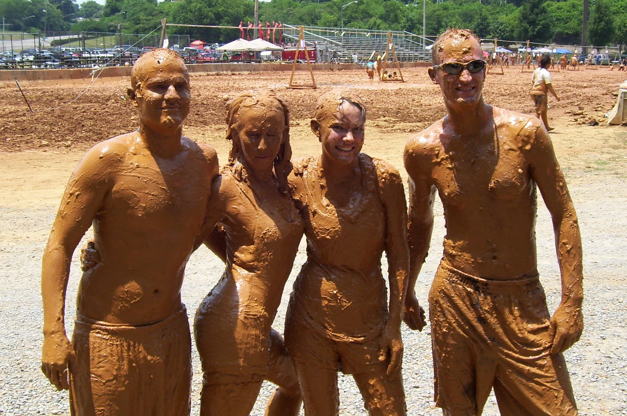 MCGHEE  TYSON ANGB, Tenn. - Airman Leadership School Class 10-4 students (L-R) Senior Airman Joshua V. Fleming, Senior Airman Sharon M. Gouchie, Senior Airman Devin A. Waddell, and Senior Airman Shawn O. Scott help raise more than $20,000 for the Epilepsy Foundation of East Tennessee during the organization's annual Mud Volleyball Tournament at Chilhowee Park in Knoxville, June 26, 2010. (U.S. Air Force photo by Master Sgt. Michael Moore/Released)