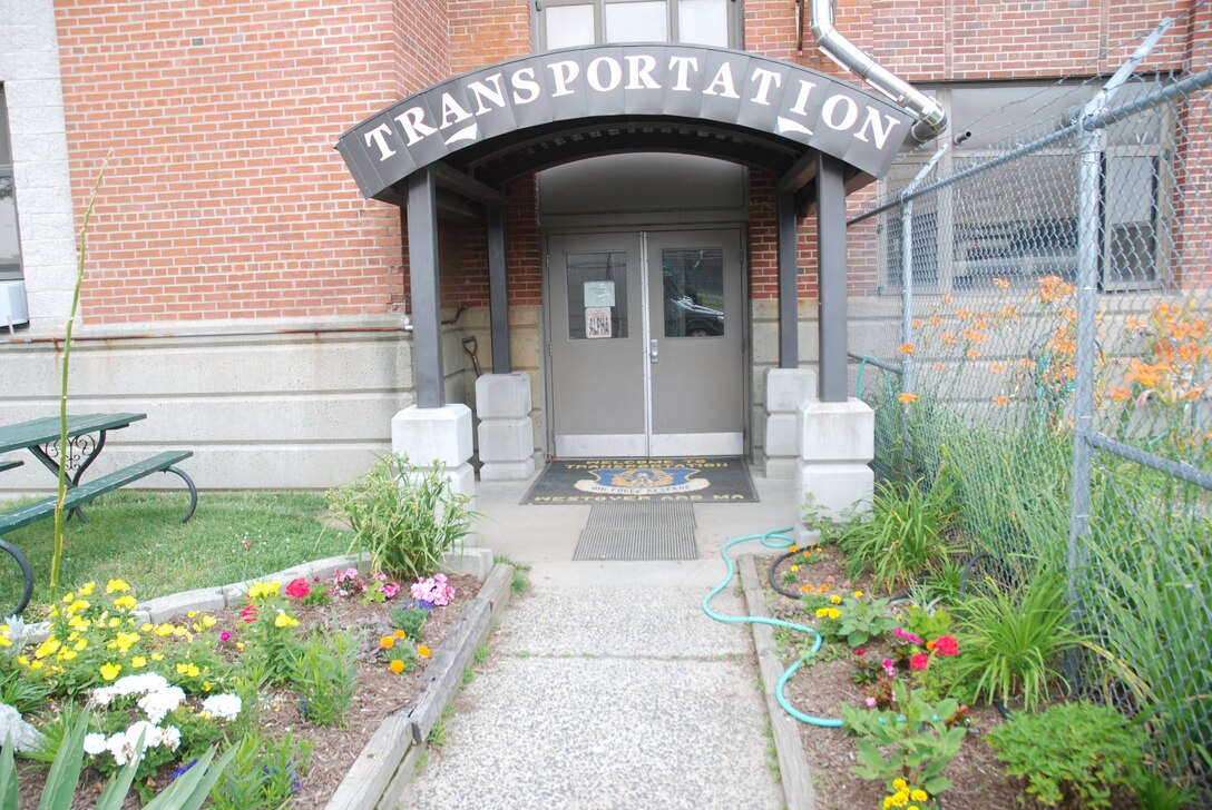 Just outside of Hangar 5, at the side entrance to the 439 Logistics Readiness Squadron's Vehicle Operations office, a garden flourishes. Although the garden is somewhat obscured from the eyes of passersby, this natural wonder has been in place since 2001. The garden is the joint effort of Airmen and civilians. (Air Force Photo/Andre Bowser)