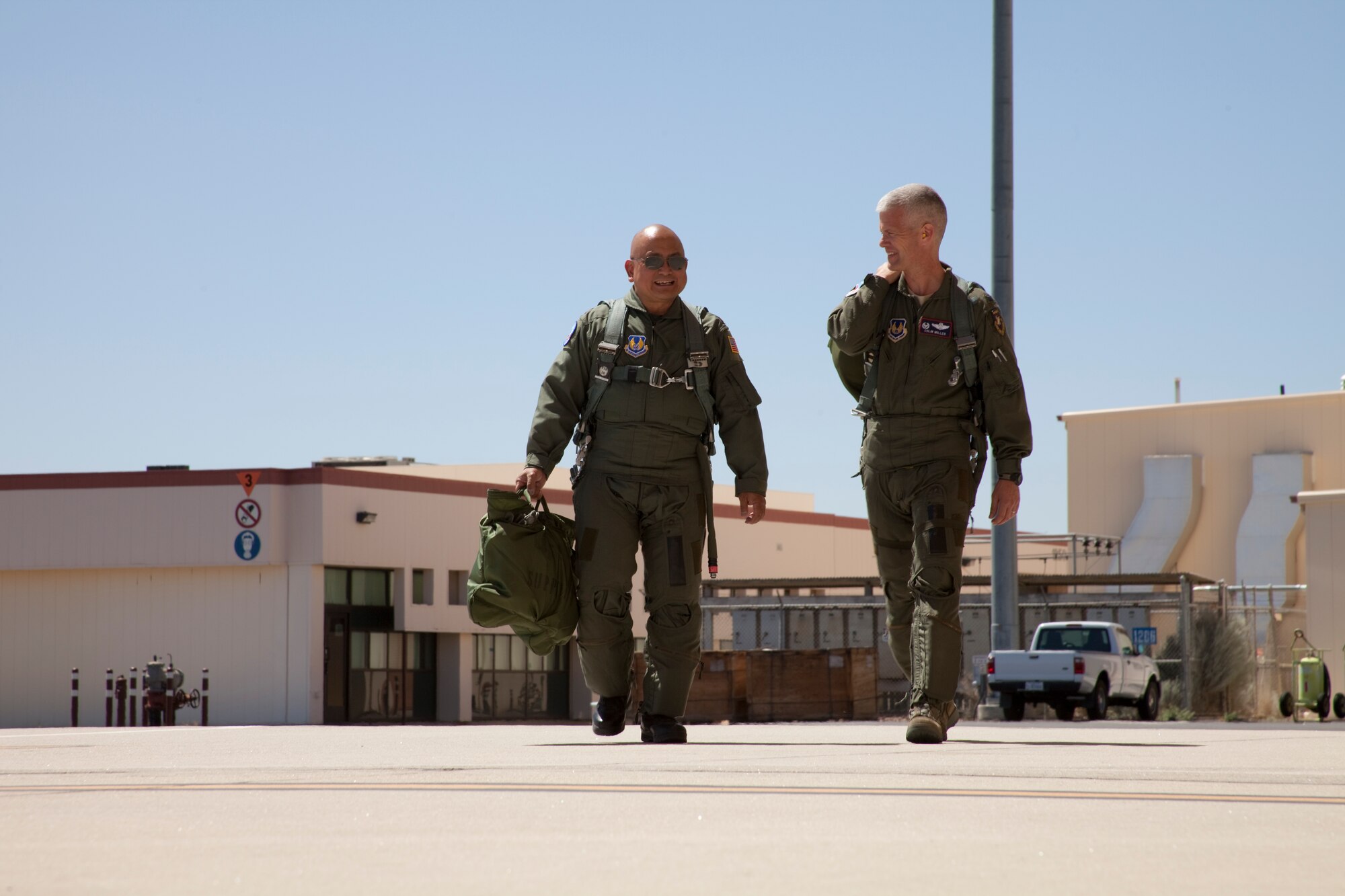 Chaplain (Maj.) Phillip Llanos, 95th Air Base Wing chaplain's office (left), and Col. Colin C. Miller, 412th Operations Group commander,  flew in an F-16D June 16.  Colonel Miller took Chaplain Llanos on an incentive flight to mark his retirement, June 30. Chaplain Llanos is retiring after more than 20 years in the Air Force.  He has been hired on as a civilian priest here at Edwards. (Air Force photo by Greg L. Davis) 