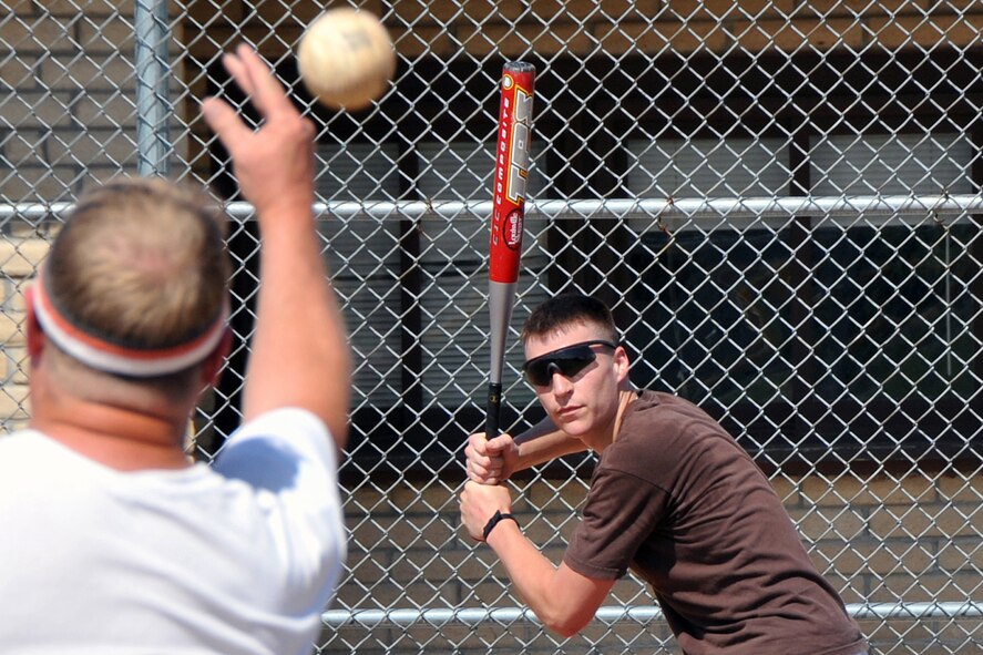 OFFUTT AIR FORCE BASE, Neb. - Thomas "Ski" Niemczynski, from the 2d Systems Operations Squadron softball team, gets in some batting practice June 24 with the rest of the team. The 2010 intramural softball season began June 28 with 20 teams all vying for the title of base champion. U.S. Air Force photo by Jeff W. Gates.