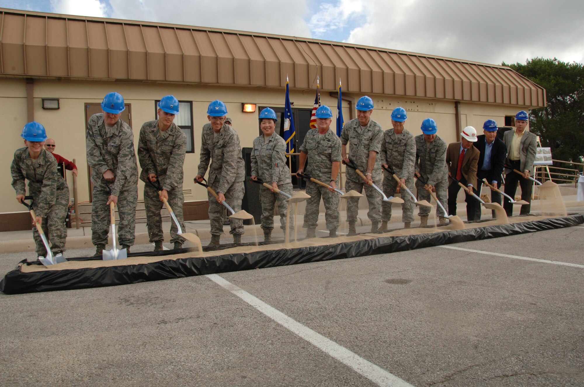 Maj. Gen. Thomas Travis, 59th medical wing commander, and key memebers shovel sand, symbolizing the begining of construstion on MacKowan dental clinic 24 June. (Photo by SrA Josie Walck)