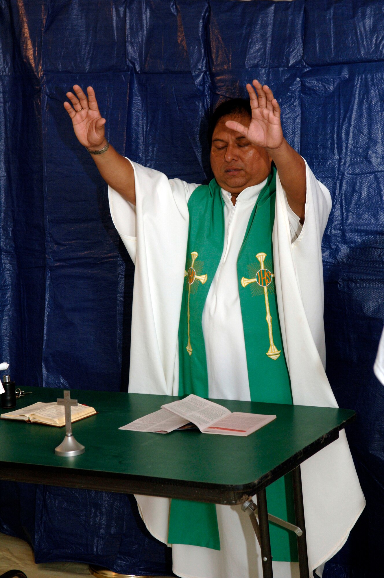 Father Jose Rodriquez leads a congregation of Task Force New Horizons service members in a Catholic service June 27. Father Rodriguez, a Panamanian missionary in the Darien province, volunteered to assist the task force chaplain during New Horizons Panama 2010, a 12-week humanitarian assistance mission designed to improve critical infrastructure and provide free medical care to the people of Panama. (U.S. Air Force photo/Tech. Sgt. Eric Petosky)