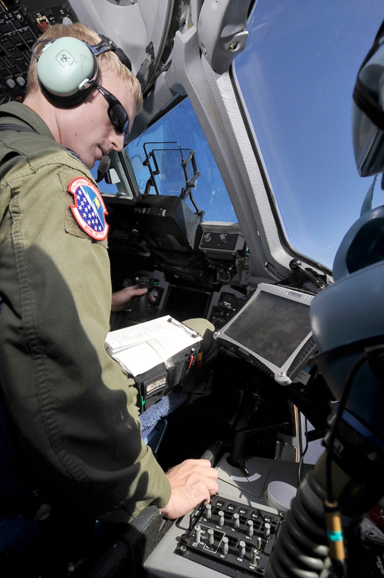 Capt. Michael Boyer checks a map and the GPS readings of a 535th Airlift Squadron C-17 Globemaster III before conducting an airdrop delivery of 90,000 pounds of supplies to Marines from Marine Corps Base Hawaii, Kaneohe Bay, June 24, 2010, while flying above Hawaii in support of the Rim of the Pacific exercise. Captain Boyer is a 535th Airlift Squadron pilot. (U.S. Air Force photo/Tech. Sgt. Cohen A. Young)