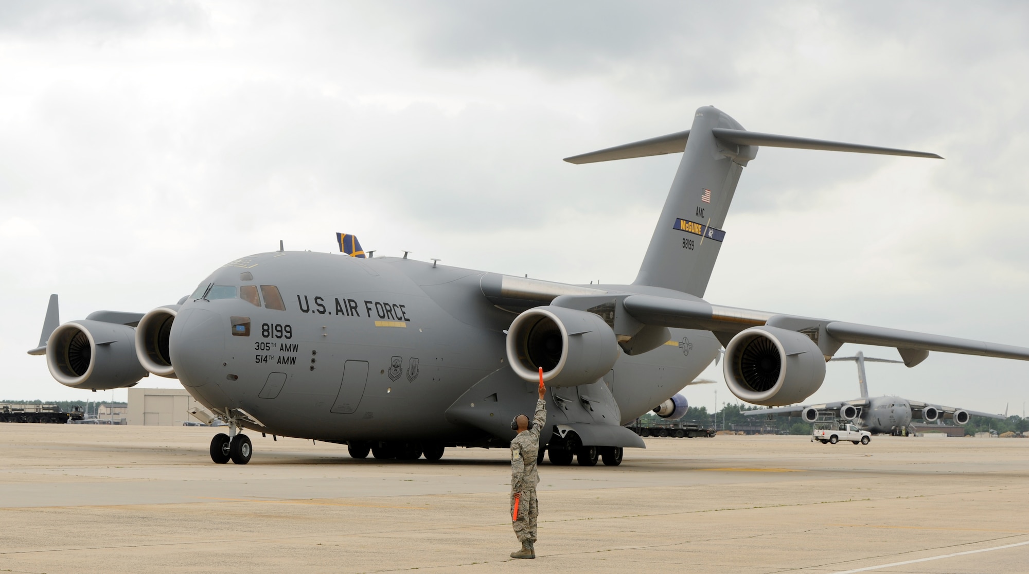 Staff Sgt Joshua Hernandez, 514th Air Mobility Maintenance Squadron aircraft mechanic, watches the wing-tips of Joint Base McGuire-Dix-Lakehurst’s newest C-17 Globemaster III cargo plane, as it maneuvers to its parking spot June 16. Three new C-17s were assigned to the 305th Air Mobility Wing as part of a congressionally-approved increase in the aircraft throughout Air Mobility Command. The first of the C-17 aircraft arrived here May 14. (U.S. Air Force photo/Wayne Russell)