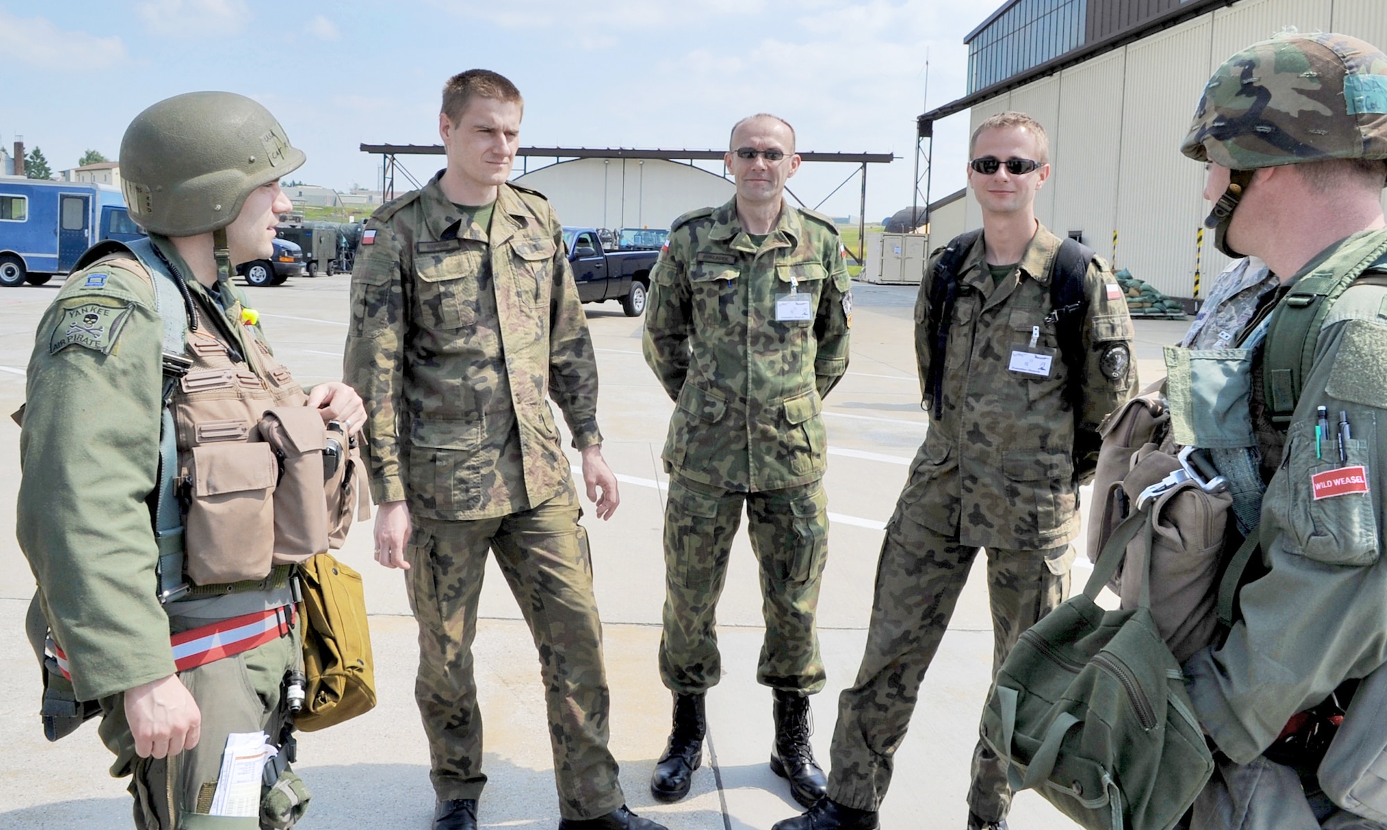 (Clockwise from the right) Lt. Col. Paul Murray and Capt. Robert Sandwith meet Polish air force members Capt. Chris Marciak, Maj. Andriej Pokladek and Lt. Mariusz Choszczewski during a U.S. Air Forces in Europe Operational Readiness Inspection June 23, 2010 at Spangdahlem Air Base, Germany. Colonel Murray and Captain Sandwith are pilots from the 22nd Fighter Squadron and the Polish airmen are assigned to the 32nd Air Tactical Base, Poland. (U.S. Air Force photo/Airman 1st Class Nick Wilson)