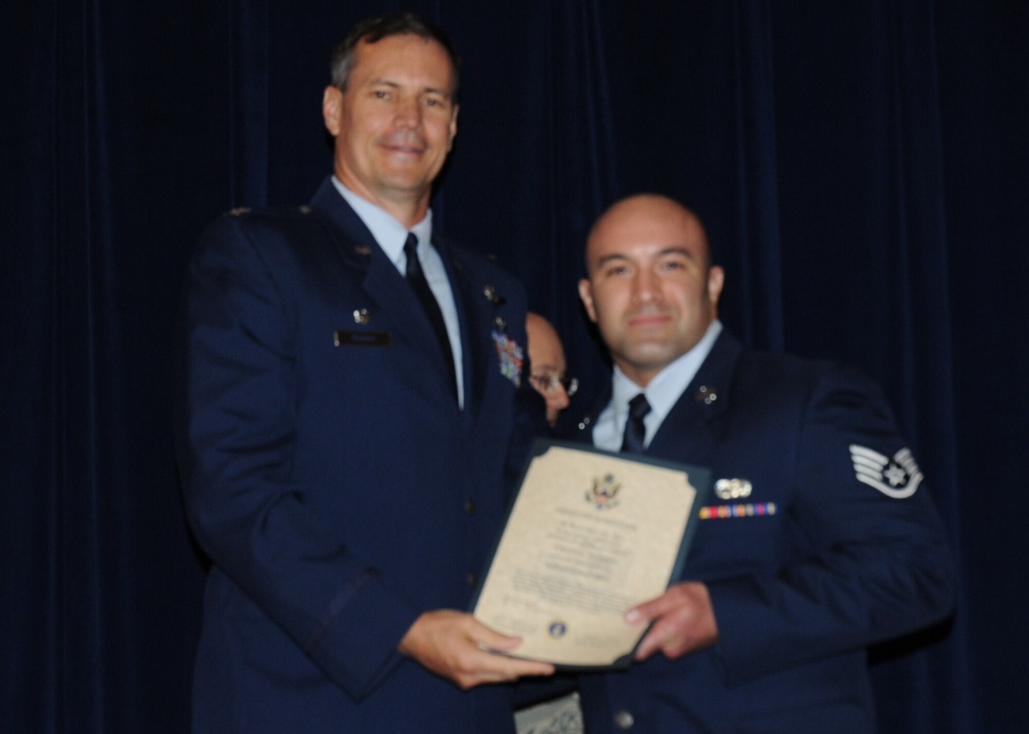 Colonel Michael Popovich, 944th Fighter Wing commander, welcomes Staff Sgt. Joseph Sowden, 944th Logistics Readiness Squadron, into the rank of NCO during the 944th Fighter Wing induction ceremony June 5, 2010. (U.S. Air Force photo/Staff Sgt. Denise Willhite)