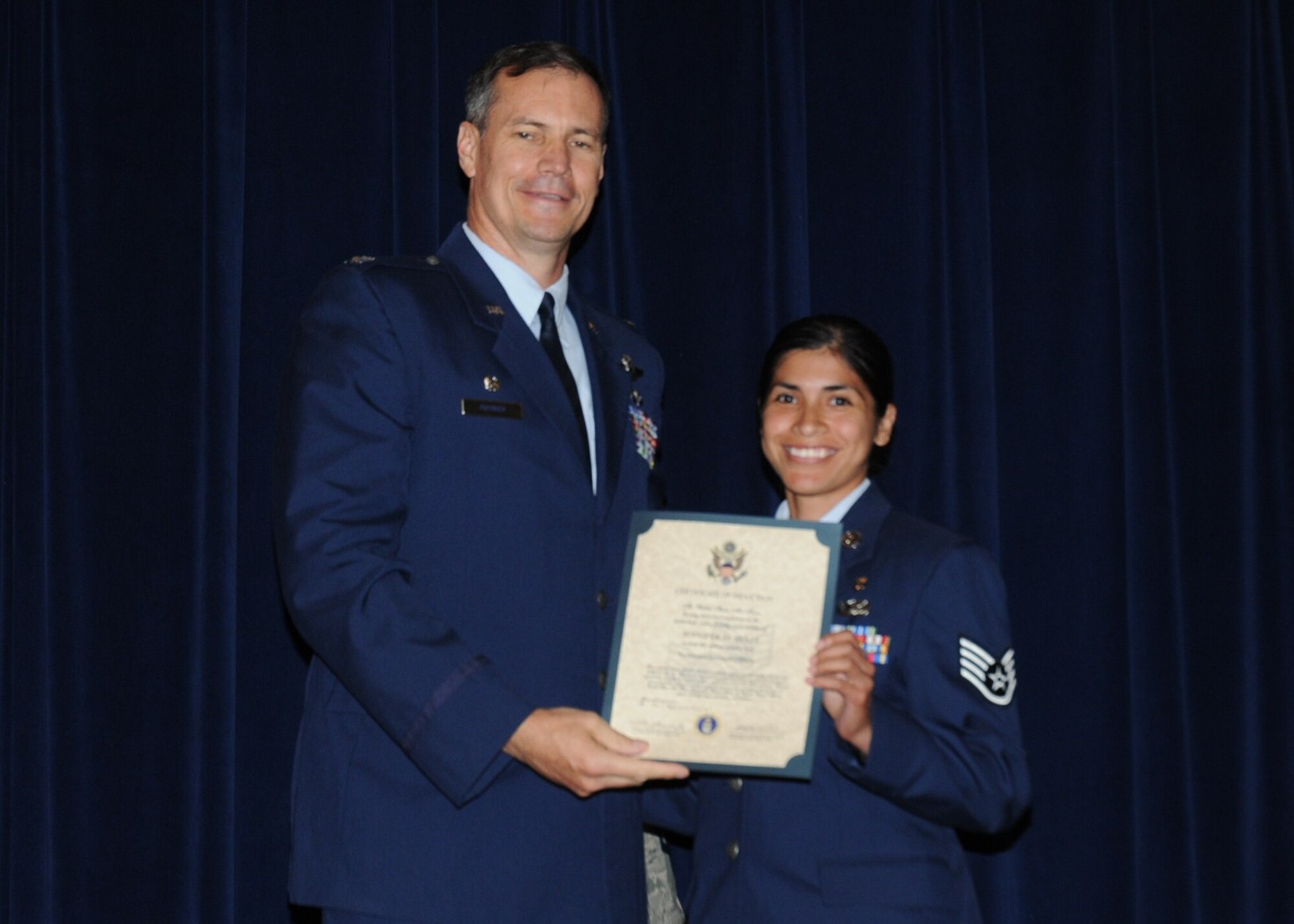 Colonel Michael Popovich, 944th Fighter Wing commander, welcomes Staff Sgt. Jennifer Seale, 944th Medical Squadron, into the rank of NCO during the 944th Fighter Wing induction ceremony June 5, 2010. (U.S. Air Force photo/Staff Sgt. Denise Willhite)