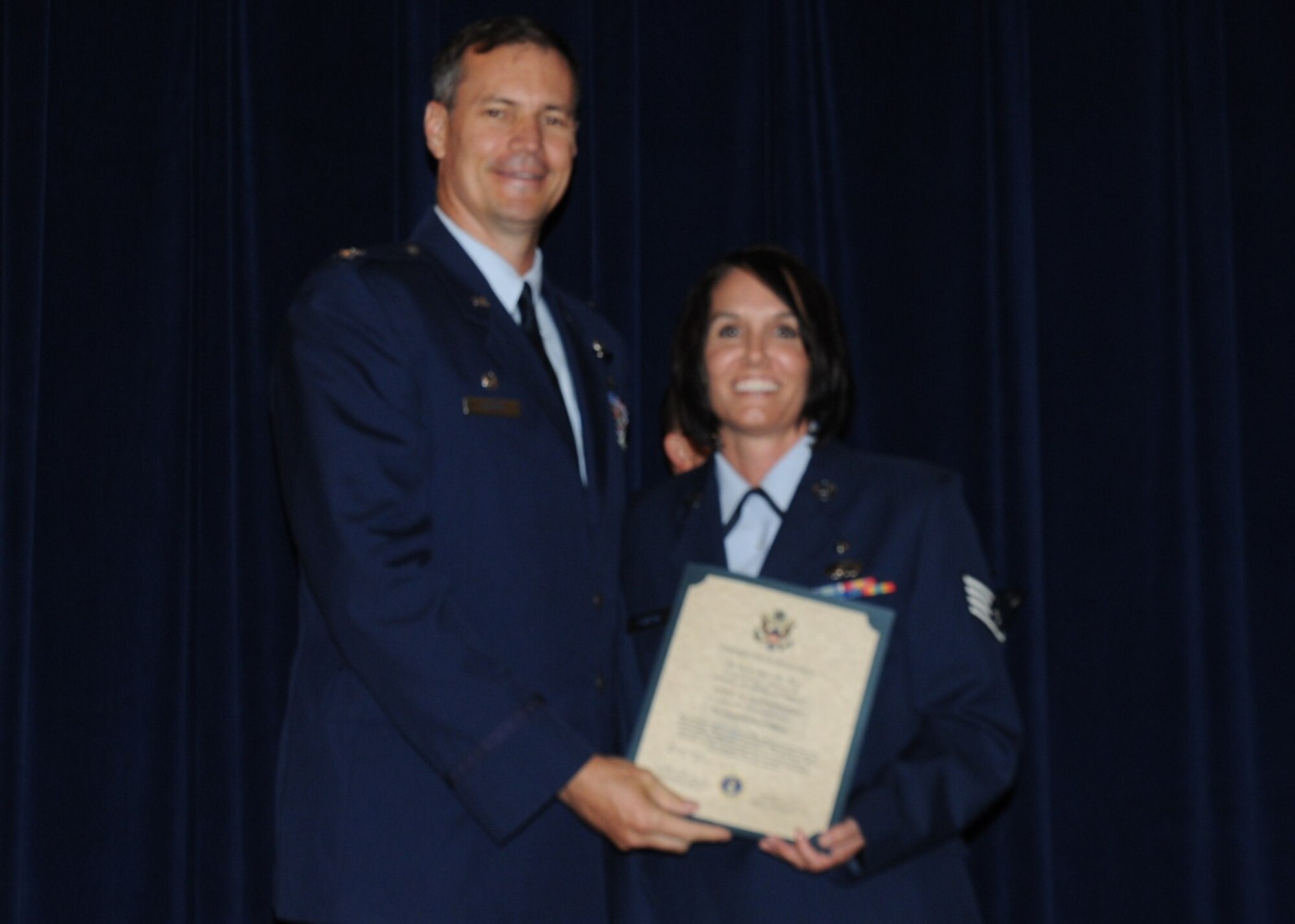 Colonel Michael Popovich, 944th Fighter Wing commander, welcomes Staff Sgt. April Sansoterra, 944th Mission Support Flight, into the rank of NCO during the 944th Fighter Wing induction ceremony June 5, 2010. (U.S. Air Force photo/Staff Sgt. Denise Willhite)