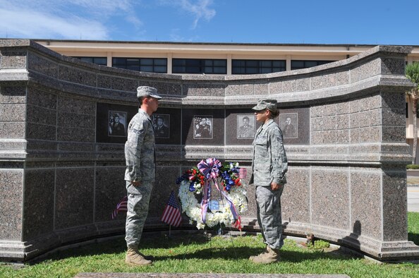 PATRICK AIR FORCE BASE, Fla. -  Senior Airman Rudolph Panacci, reservist from the 308th Rescue Squadron, and Staff Sgt. Stacie Greer, reservist from the 920th Operations Support Flight, place the wreath at the memorial site of the five fallen airmen during the ceremony June 25 here. This marks the 14th anniversary of the tragedy. (U.S. Air Force Photo/ John Connell)