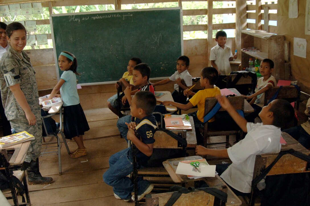 Senior Airman Tiffany Valencia, 820th Expeditionary RED HORSE Squadron personnel specialist, visits with children in a makeshift classroom at Santa Librada elementary school June 19. The 372nd Engineer Company, and Army Reserve unit deployed in support of New Horizons Panama 2010, will replace classrooms like this with a new school house. (U.S. Air Force photo/Tech. Sgt. Eric Petosky)