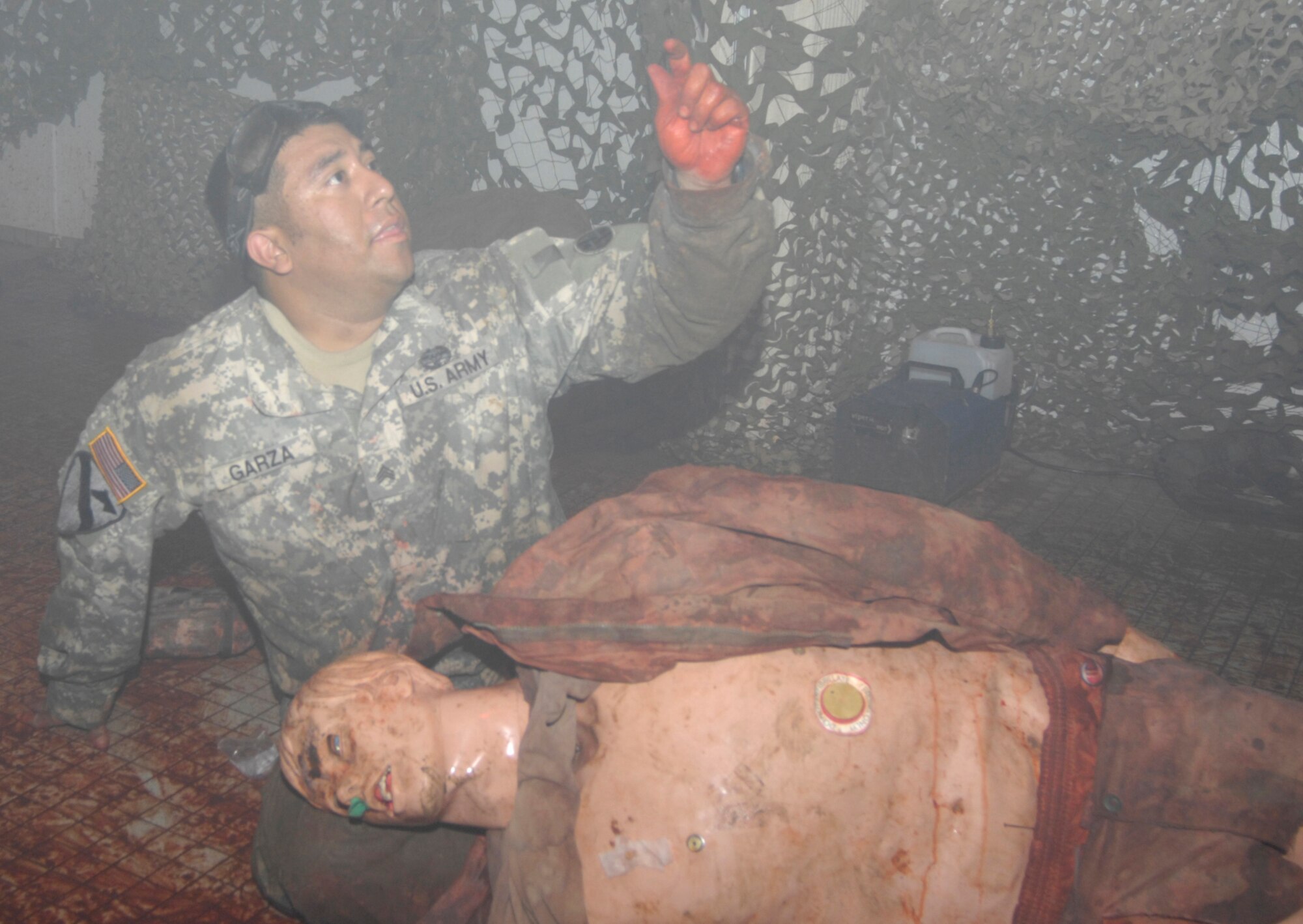 Sgt. Monty Garza, 288th Quartermaster, calls for help during a June 12 training exercise at the Medical Simulation Training Center. Soldiers had to enter a dark room, evaluate casualties and provide any medical assistance they could. The ASA-Dix MSTC was awarded this year's Cpl. Angelo J. Vaccardo Award, which is given yearly by the U.S. Army Medical Department to the best medical training facility in the Army. (U.S. Army photo/Ed Mingin)