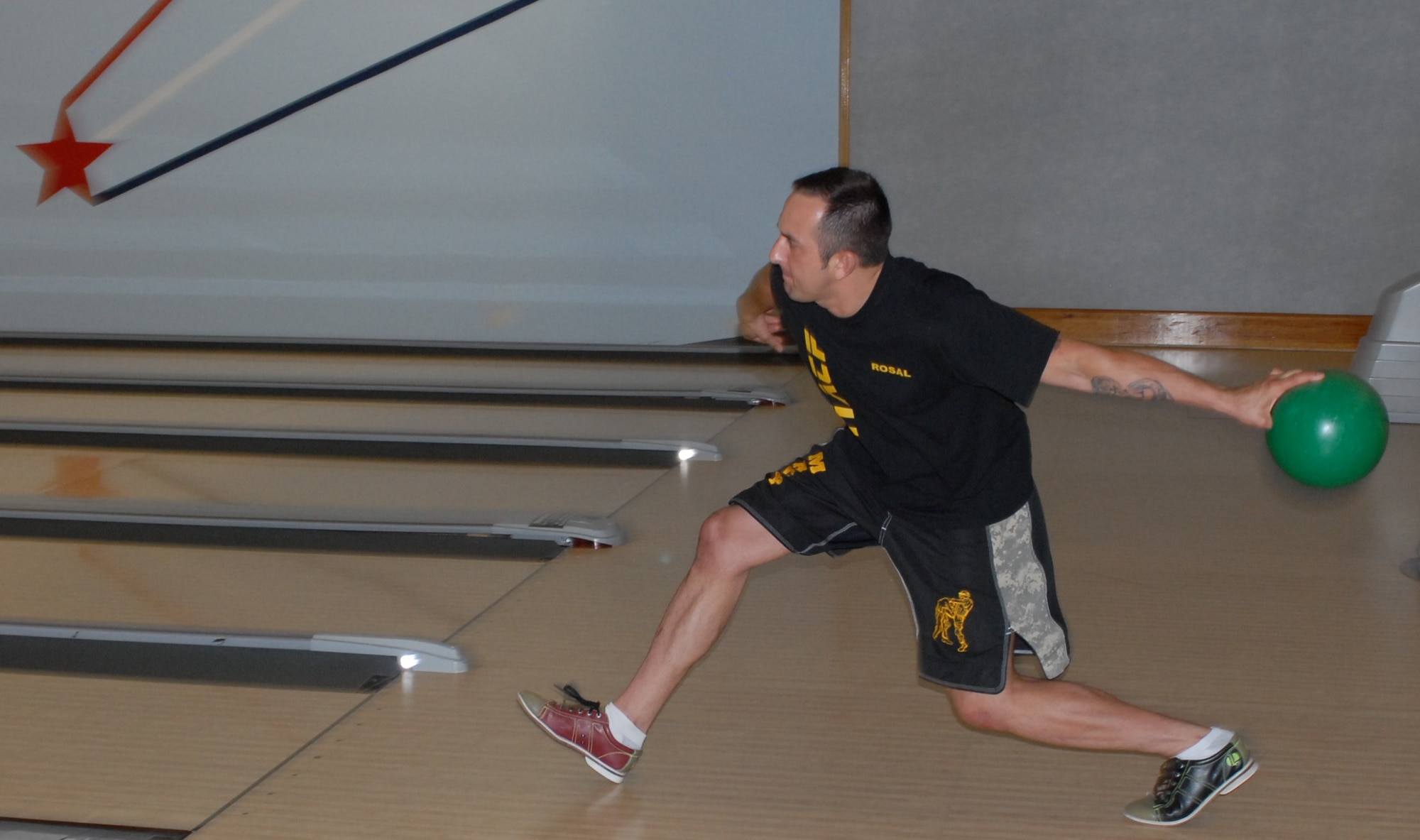 Sgt. 1st Class Jorge Rosal, a Modern Army Combative3s Program instructor in the 1st Battalion, 309th Regiment, hopes for a strike during a free Father's Day bowling event, sponsored by the 1st Battalion, 309th Regiment's Family Readiness Group Monday. (U.S. Army photo/Sgt. Nicole Dykstra)