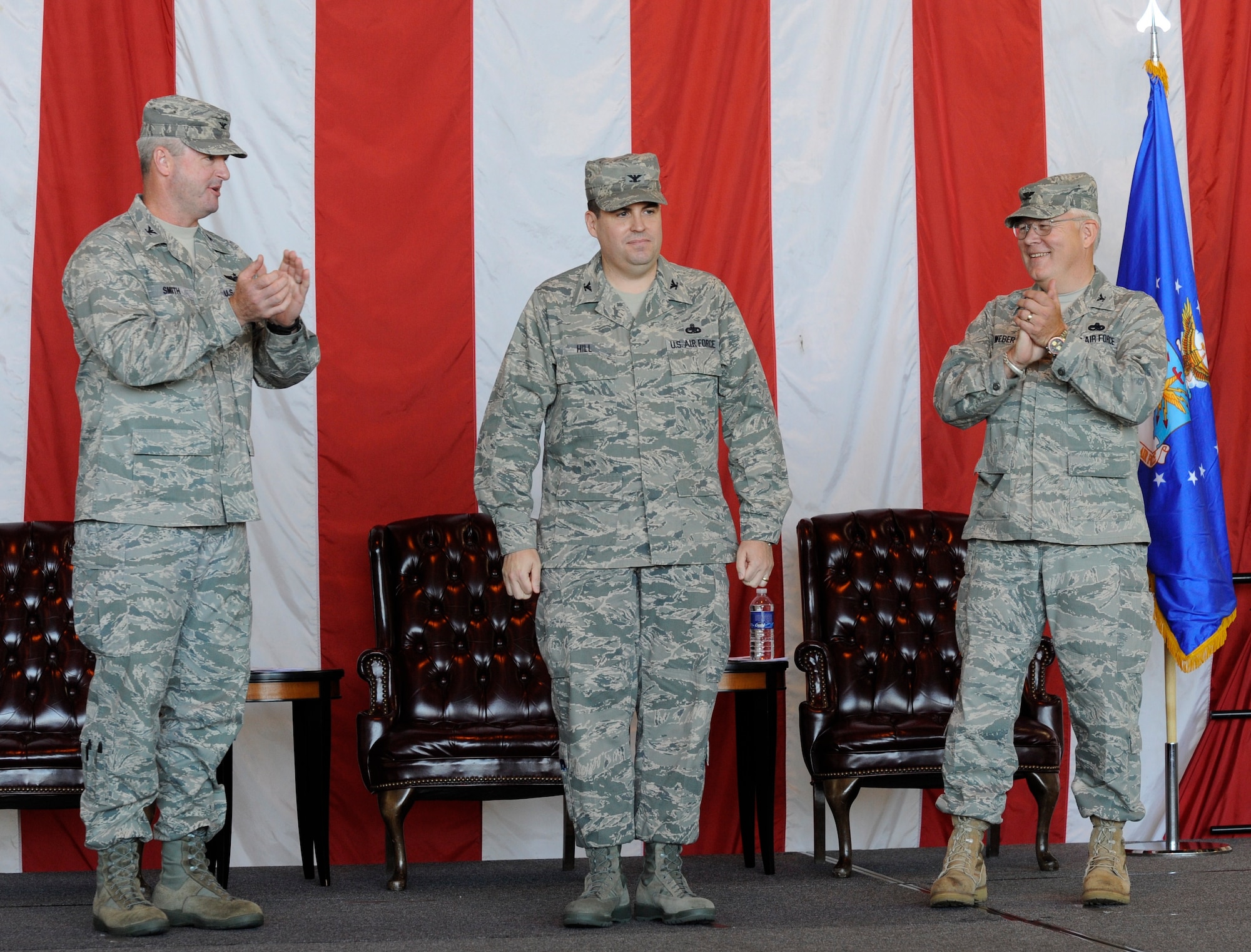 The 305th Air Mobility Wing Commander Col. Scott F. Smith and Col. James M. Weber, 305th Maintenance Group outgoing commander, welcome Col. Charles W. Hill, 305th MXG incoming commander, to Joint Base McGuire-Dix-Lakehurst during a change of command ceremony here June 15. (U.S. Air Force photo/Carlos Cintron)