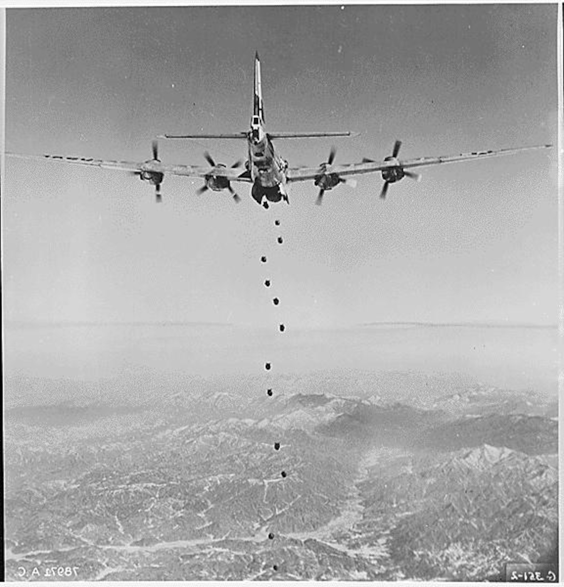 THE NATIONAL ARCHIVES - Bombs Away-Regardless of the type of enemy target lying in this rugged, mountainous terrain of Korea, very little will remain after the falling bombs have done their work. This striking photograph of the lead bomber was made from a B-29 "Superfort" of the Far East Air Forces 19th Bomber Group on the 150th combat mission the 19th Bomber Group has flown since the start of the Korean war., ca. 02/1951