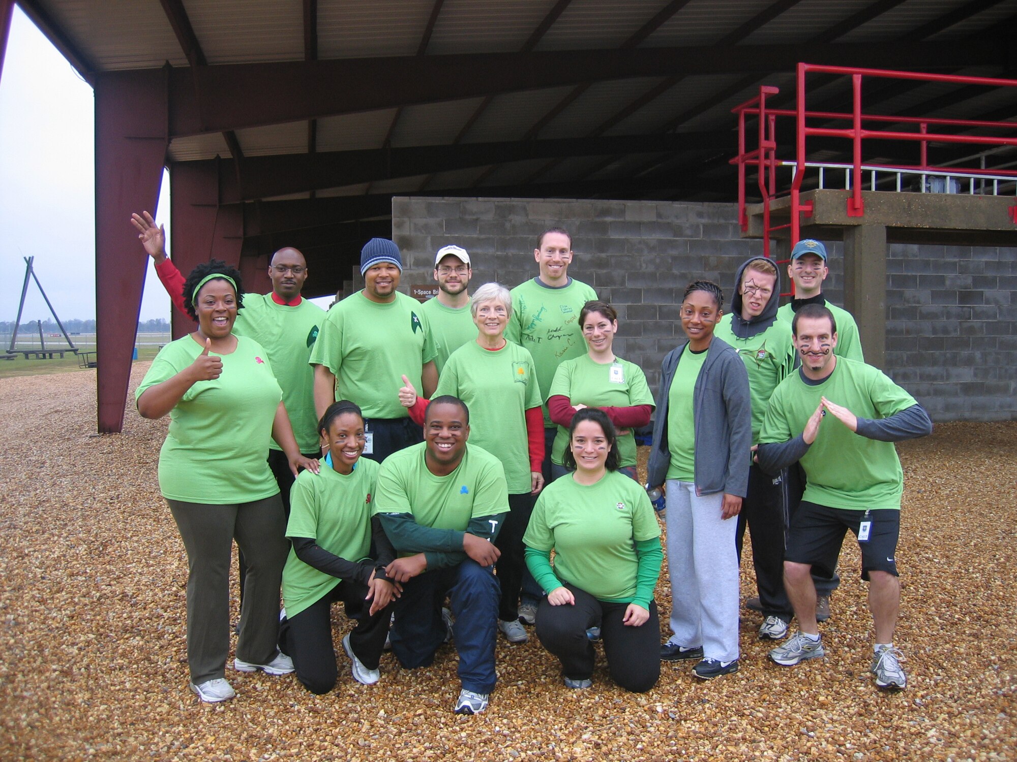 Electronic Systems Center civilians Donald Changeau (kneeling, front and center) and Elisa Esterley (middle row, 3rd from right) pose for a photo with fellow members of Alpha Flight during the Civilian Acculturation and Leadership Training at Maxwell Air Force Base, Ala. Dec. 8, 2009.  Following the photo, team members completed an obstacle course.  (U.S. Air Force photo) 