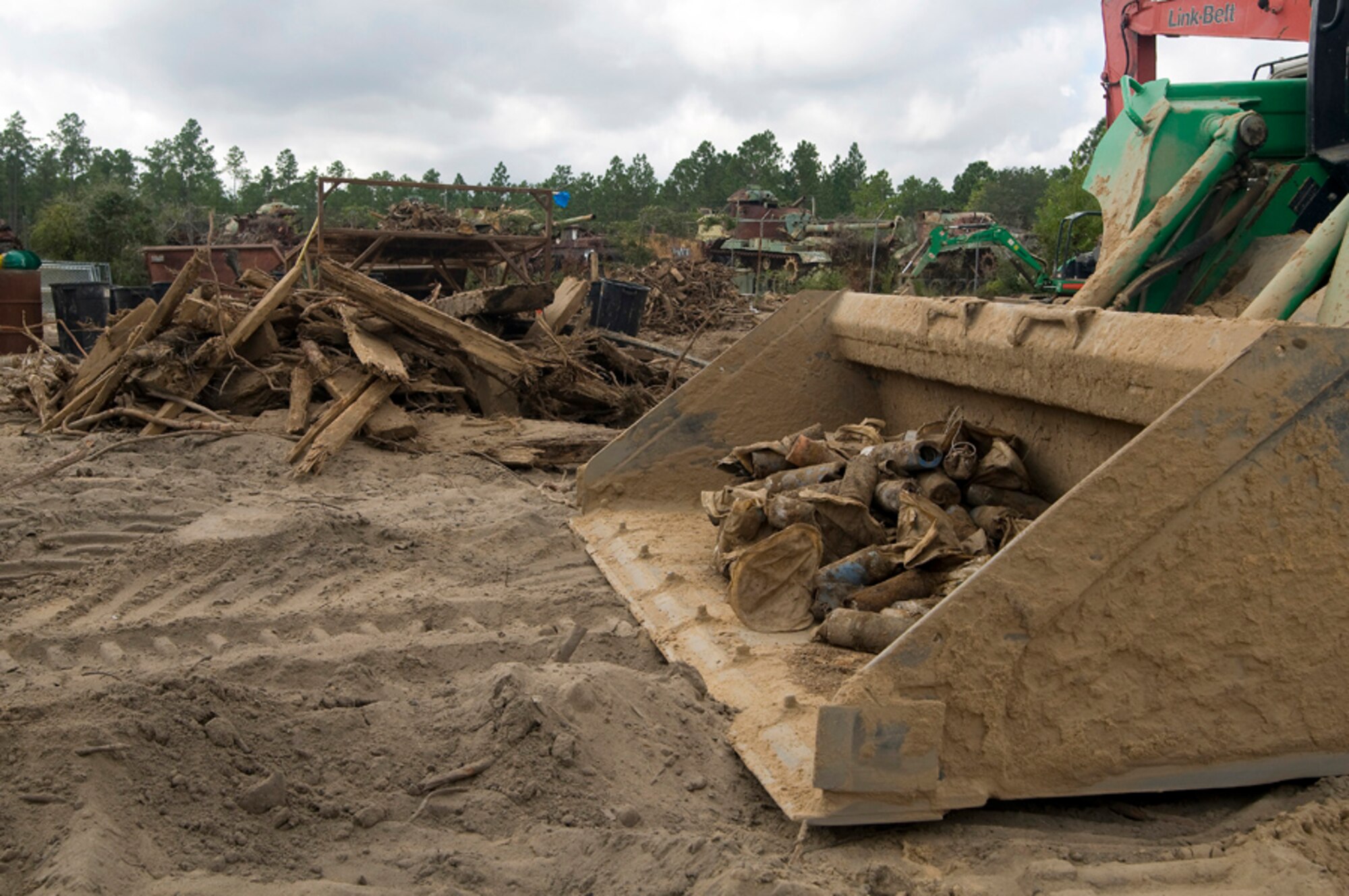 Eglin and Hurlburt Field Restoration Advisory Board community members toured a former munitions disposal pit here.  Explosive experts at the site excavate the munitions, render them safe, and send the scrap metal to a recycling plant. The tour, hosted by the 96th Civil Engineer Group Environmental Restoration Office, was intended to help inform the local community about the base’s commitment to a clean environment.  (U.S. Air Force photo/Scott Moorman.)