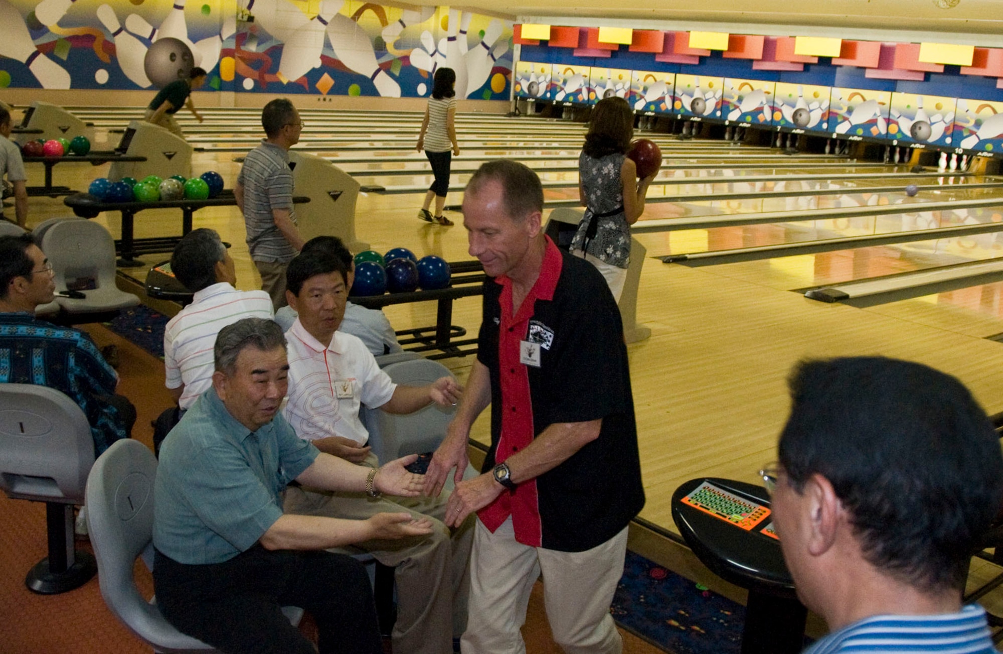 Col. David Stilwell, 35th Fighter Wing commander, celebrates with Misawa City Mayor Kazumasa Taneichi, June 26, during a friendship bowling tournament at the Walmsley Bowling Center. The community relations event strengthened ties between wing leadership, Misawa City officials and Japan Air Self-Defense Force senior leaders with off-duty bonding and competitive entertainment. (U.S. Air Force photo/Senior Airman Jessica Lockoski) 