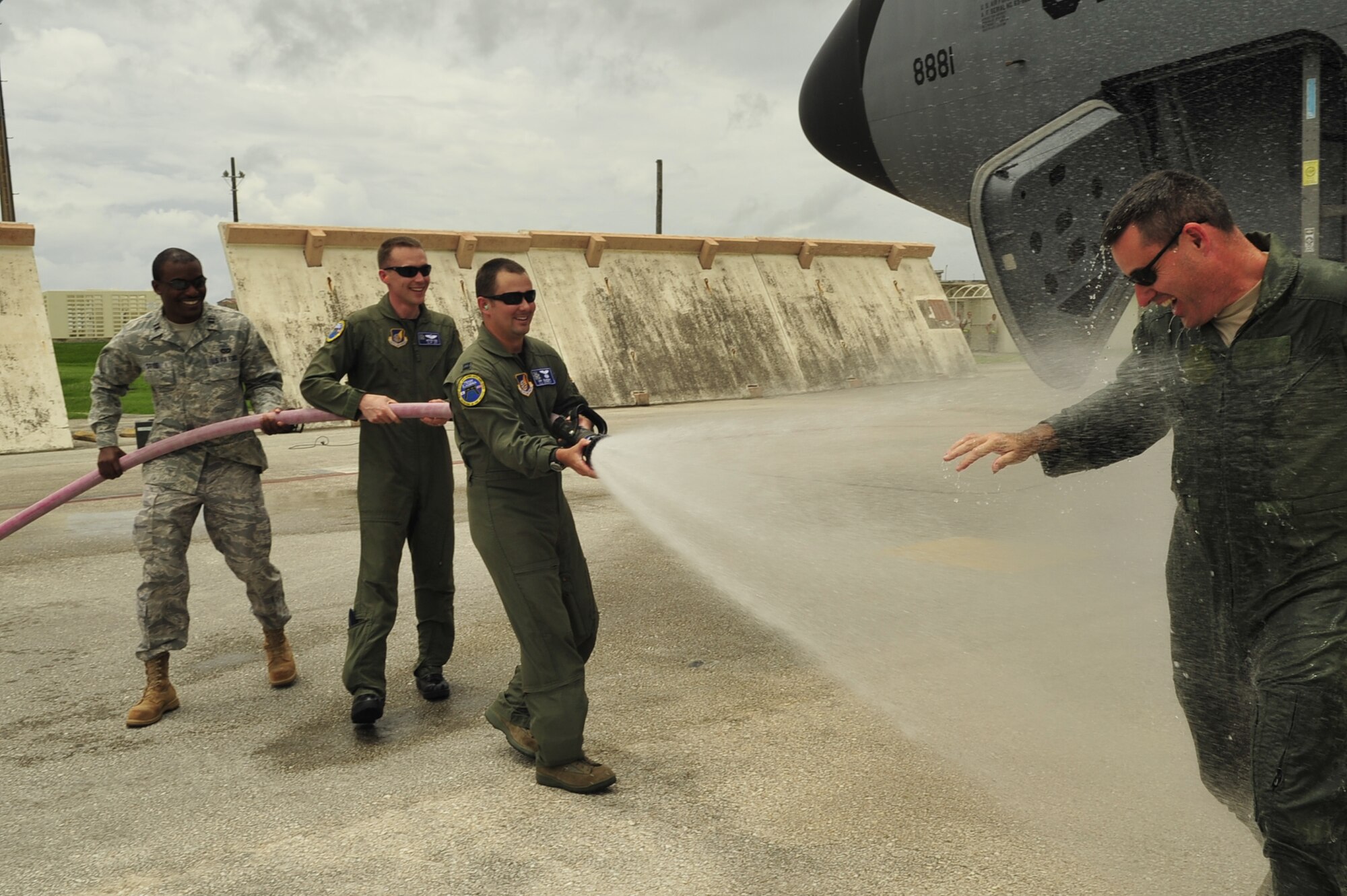 Colonel Lenny Richoux, 18th Wing vice commander, gets hosed down by the wing's executive officers following his fini-flight June 25. (U.S. Air Force photo / Senior Airman Amanda Grabiec)