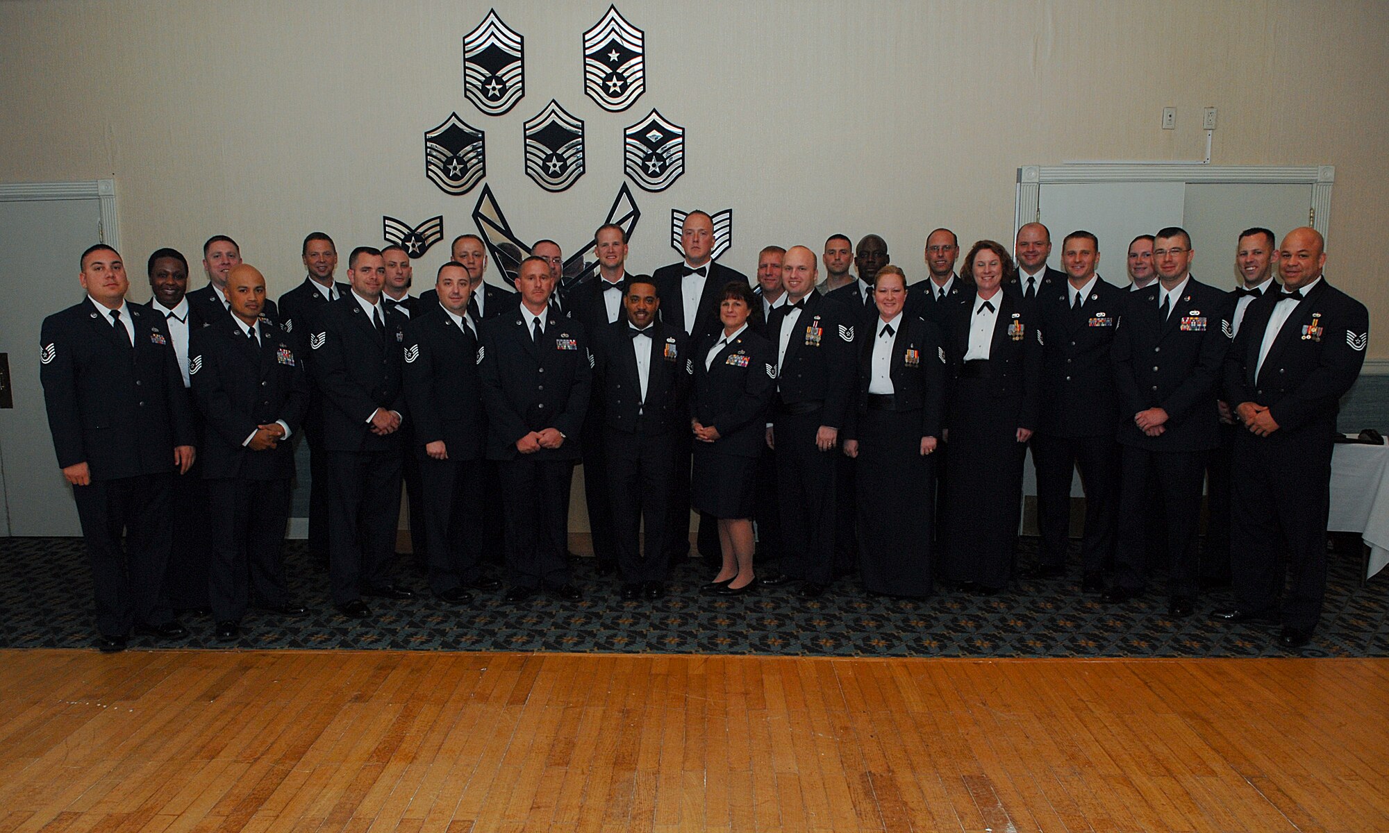Members of the Wolf Pack, who made their next promotion to master sergeant, stand for a group photo during a Senior Non-commissioned Officer Promotion Recognition banquet June 26. The purpose of the banquet was to celebrate and recognize the 33 new master sergeant selects of the Wolf Pack. (U.S. Air Force photo/Senior Airman Roy Lynch)