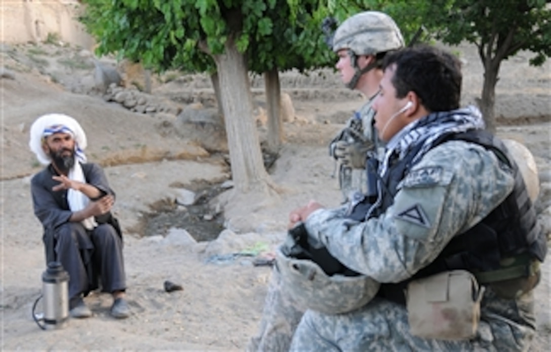 A village elder (left) talks to U.S. Army 1st Lt. Daniel Meegan, leader of the 1st Platoon, Delta Company, 1st Battalion, 4th Infantry Regiment, U.S. Army Europe, and an Afghan interpreter (right) during a key leader engagement in the village of Chino 2 outside Forward Operating Base Baylough in the Zabul province of Afghanistan on June 21, 2010.  