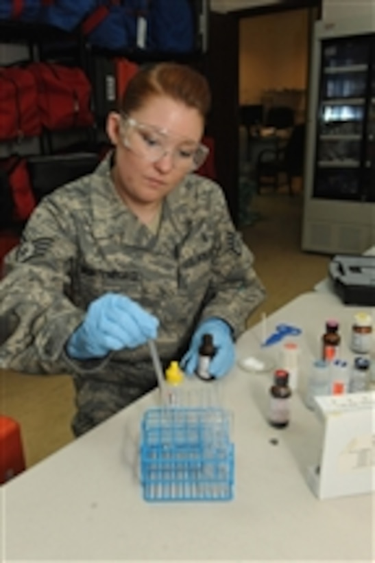 U.S. Air Force Staff Sgt. Leslie Montenegro conducts a chemical composition test at a location in Southwest Asia on June 22, 2010.  Montenegro is a bioenvironmental engineering technician from the 379th Expeditionary Medical Group.  