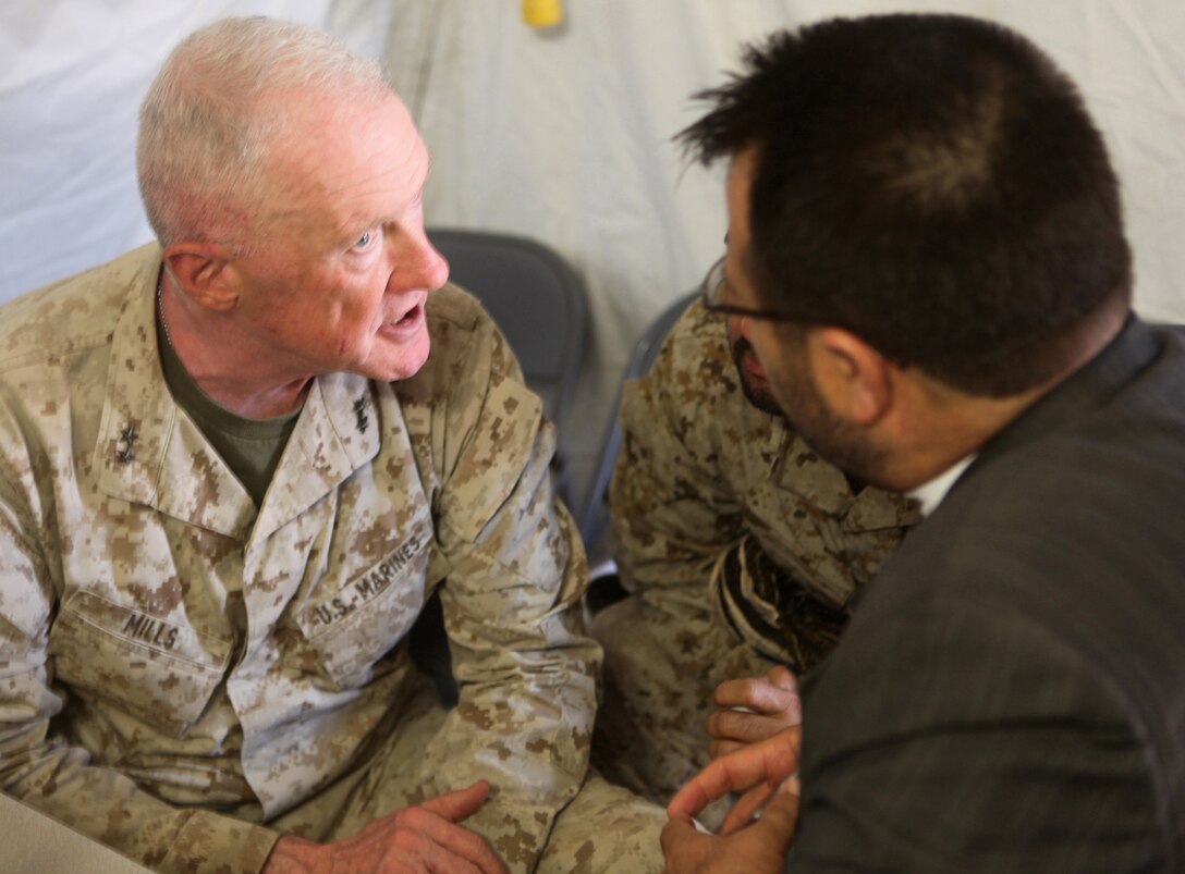 Regional Command Southwest commander, Maj. Gen. Richard P. Mills, speaks with Helmand provincial governor, Mohammad Gulab Mangal, during a security conference at Forward Operating Base Sher Wali, Marjah, Helmand province, Afghanistan, June 29, 2010. The meeting was held to discuss the emergence of the Afghan Uniform Police in Marjah, slated to replace the Afghan National Civil Order Police as the area’s local police force in the near future. Attending the event were Mills; Mangal; Marjah’s district governor, Haji Zahir and other high-ranking Marine, ANCOP and Afghan National Army officers.