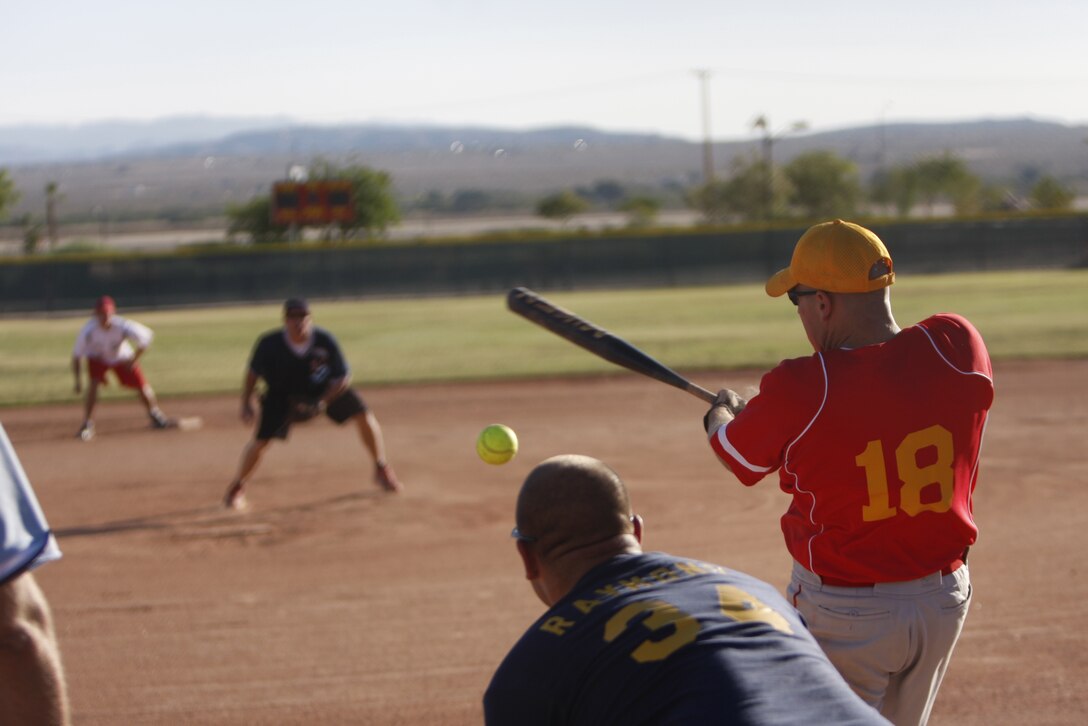 Steve McColl, an all-star with the White team, cracks away at a pitch June 30 at the Combat Center's Felix Field during the Commanding General's Intramural Softball League All-Star game. The league championship is set for July 13.
